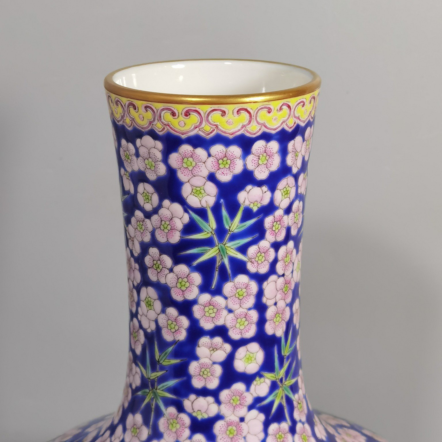 Qing Dynasty Daoguang Blue ground pastel plum and bamboo celestial sphere vase