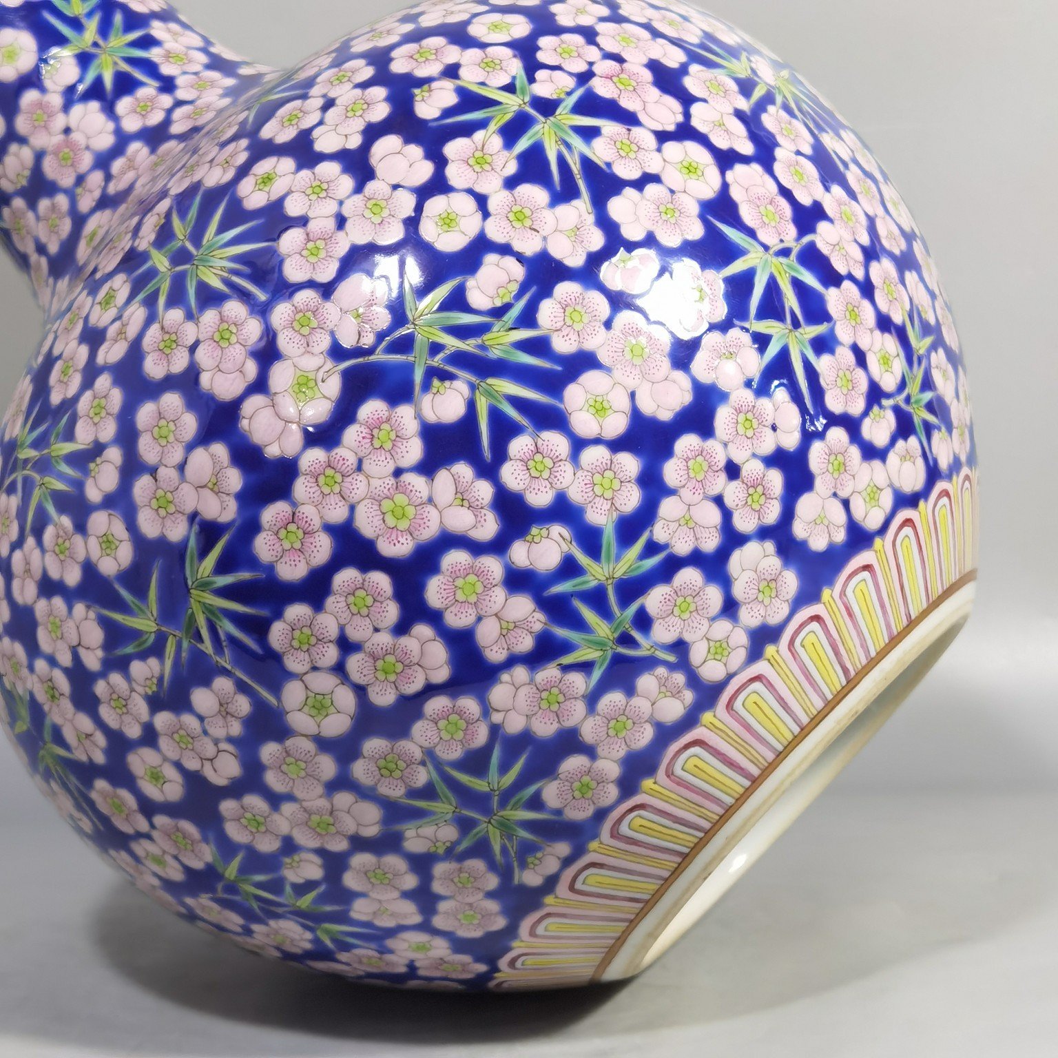 Qing Dynasty Daoguang Blue ground pastel plum and bamboo celestial sphere vase
