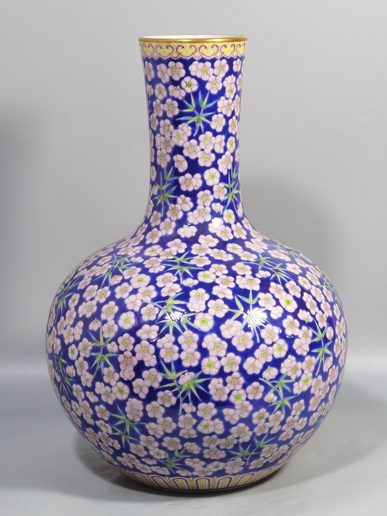 Qing Dynasty Daoguang Blue ground pastel plum and bamboo celestial sphere vase