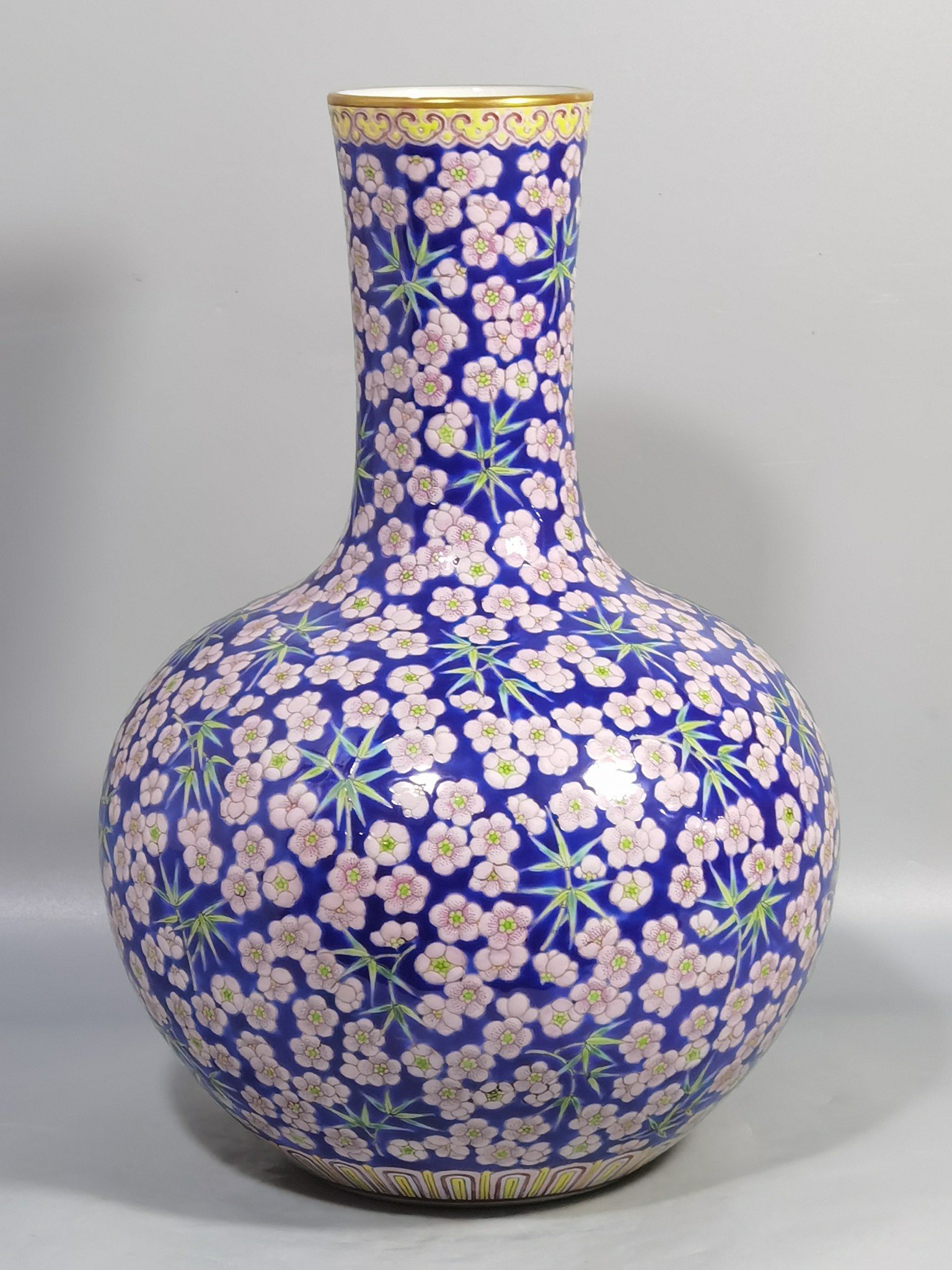 Qing Dynasty Daoguang Blue ground pastel plum and bamboo celestial sphere vase