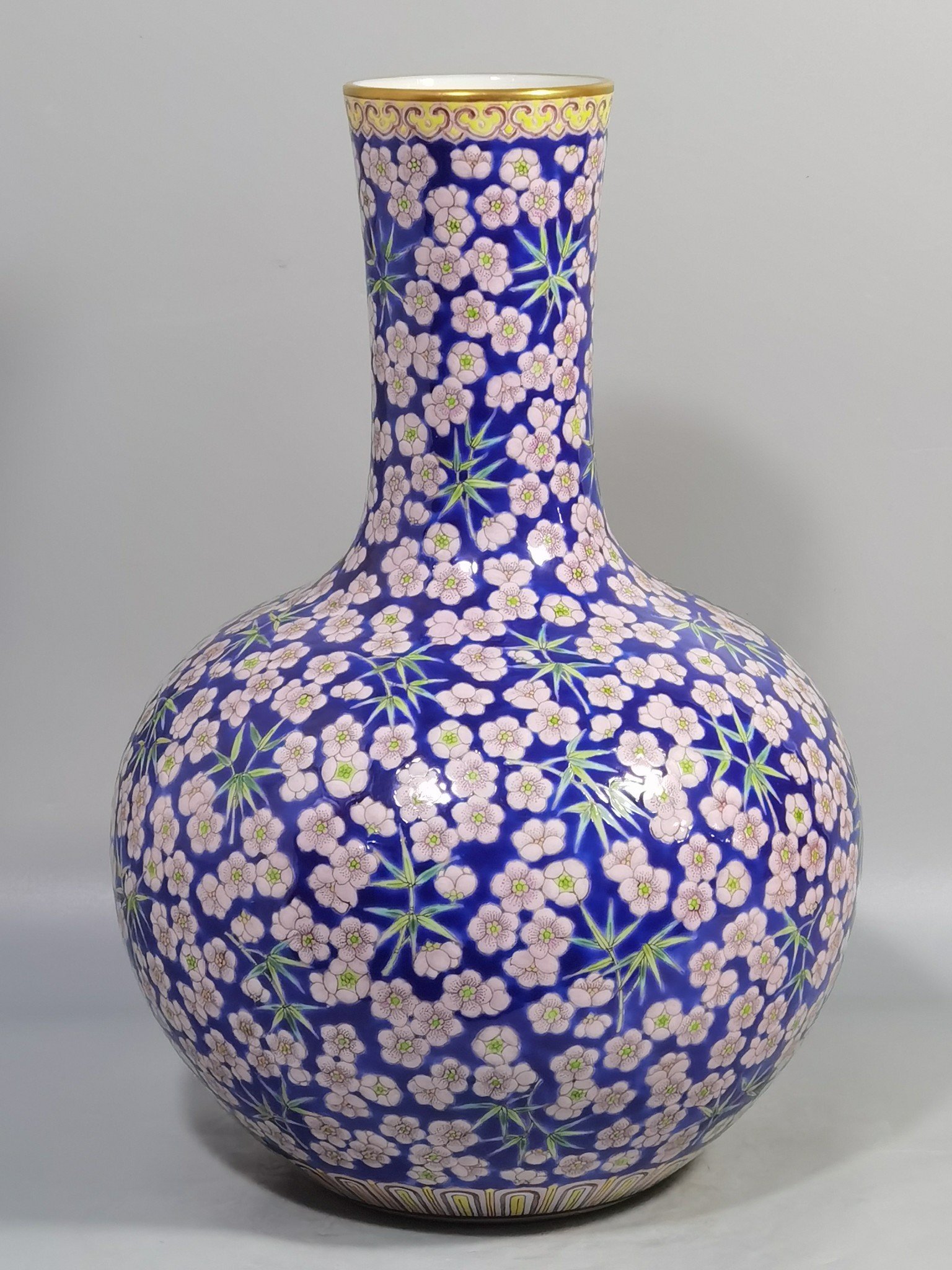 Qing Dynasty Daoguang Blue ground pastel plum and bamboo celestial sphere vase