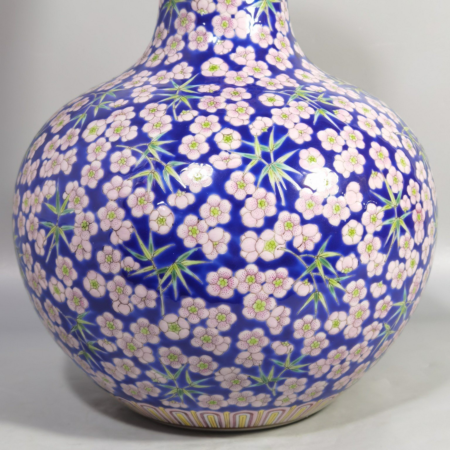 Qing Dynasty Daoguang Blue ground pastel plum and bamboo celestial sphere vase