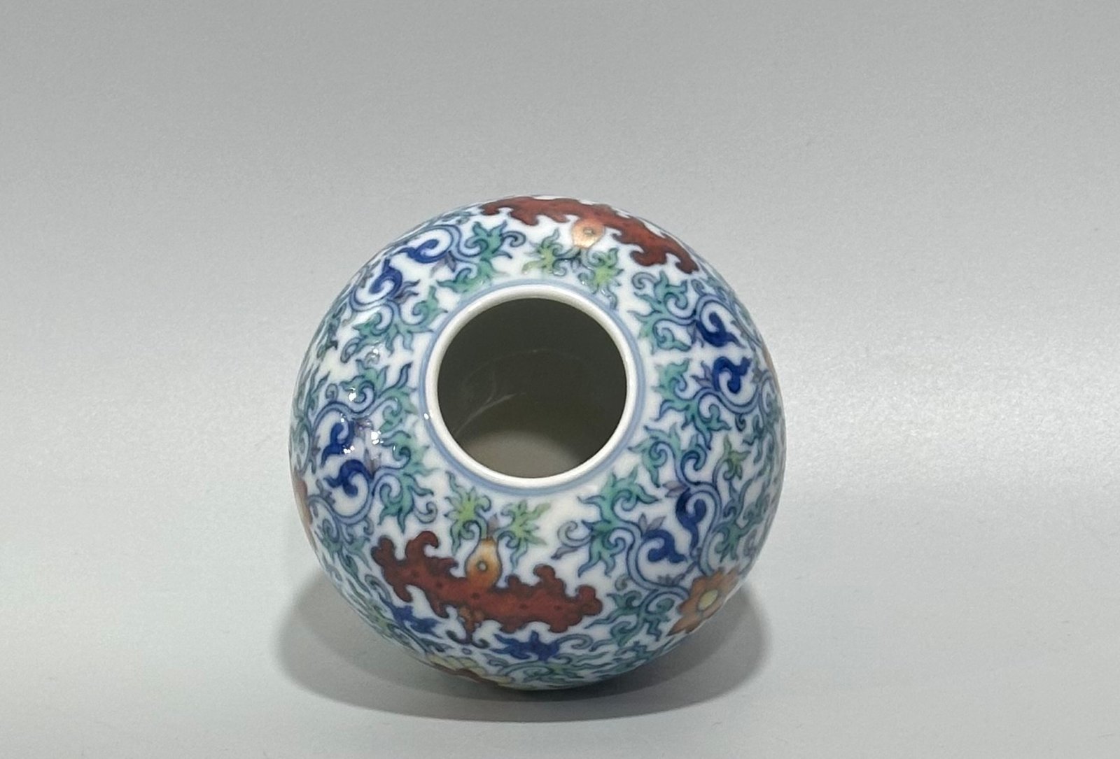 Qing Dynasty Yongzheng blue and white doucai bat flower and branch apple statue