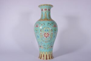 Qing Dynasty Qianlong enamel green ground and gold lotus Guanyin vase