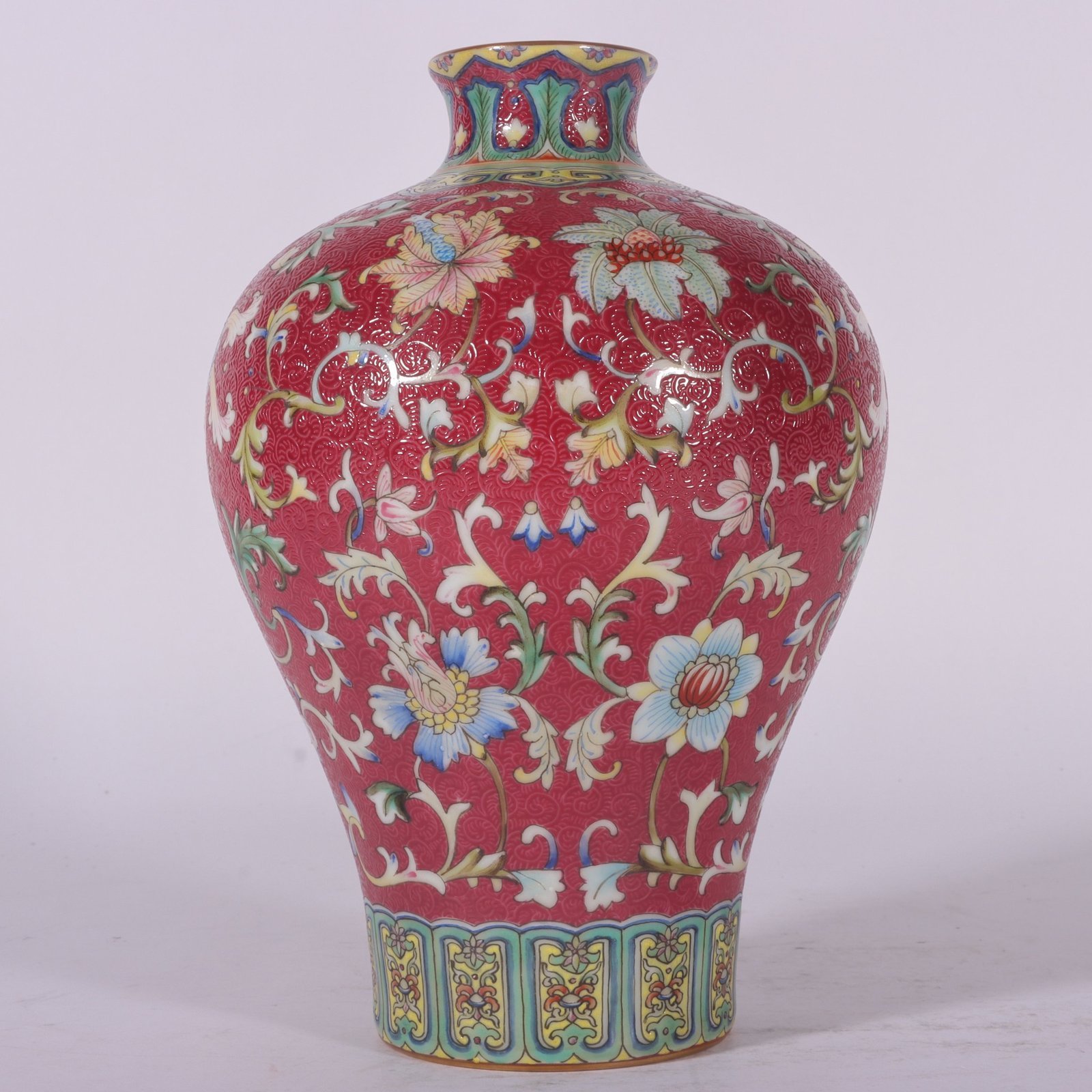 Qing Dynasty Qianlong famille rose and rouge red rolled lotus and plum vase