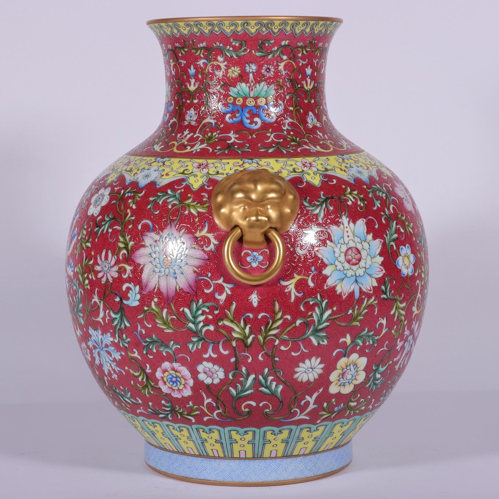 Qing Dynasty Qianlong famille rose and rouge red lotus and lion ear vase