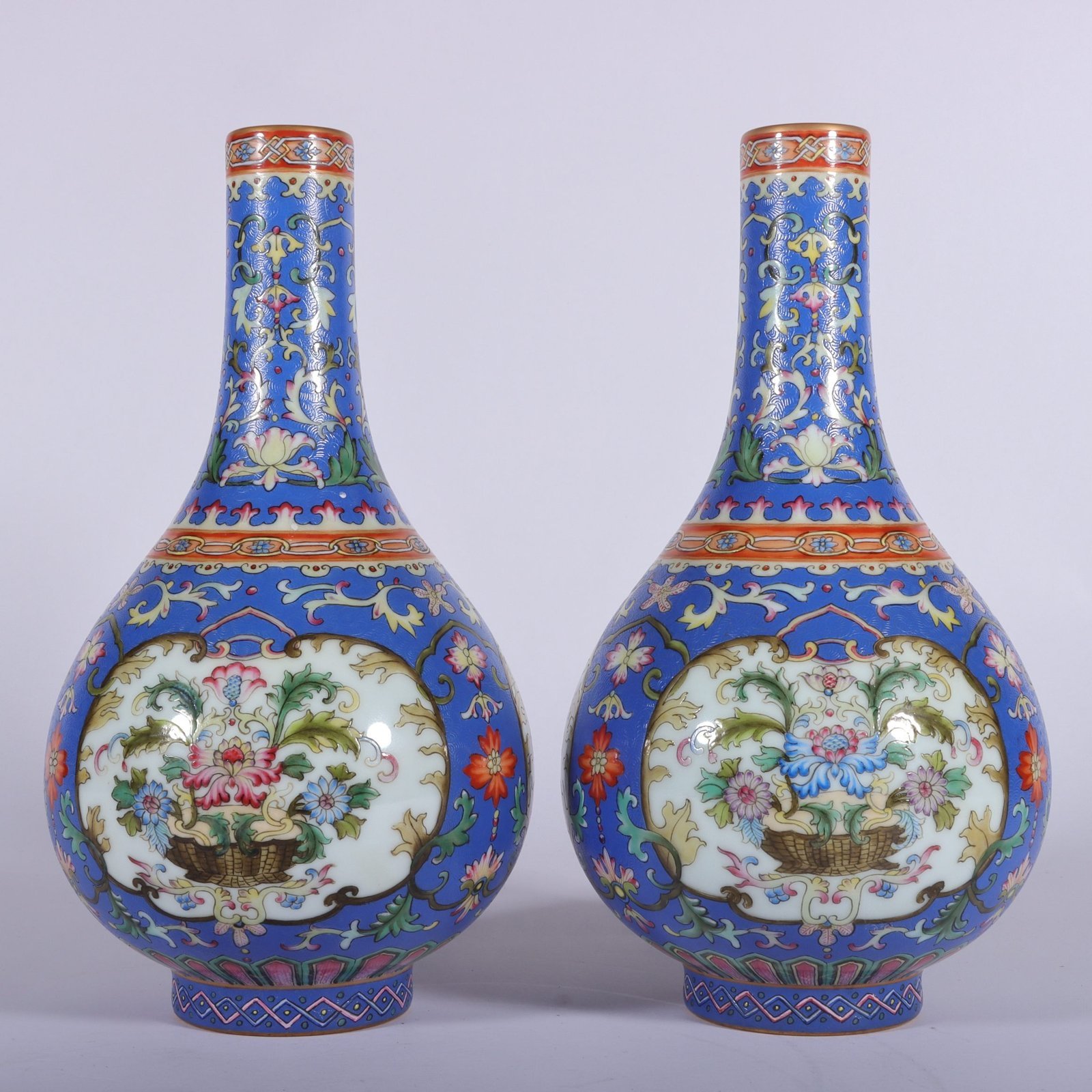 Qing Dynasty Qianlong famille rose blue ground rolled window vase