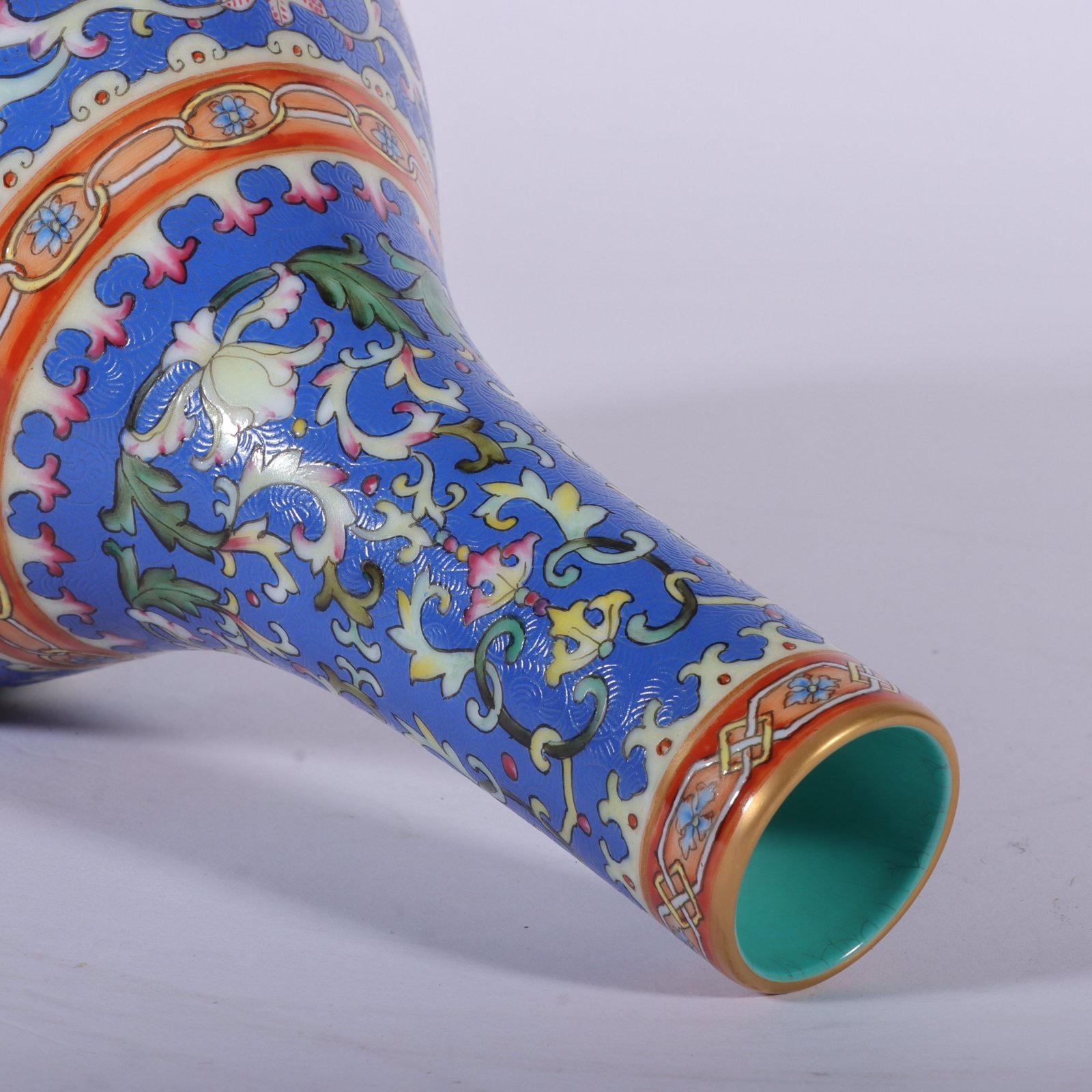 Qing Dynasty Qianlong famille rose blue ground rolled window vase