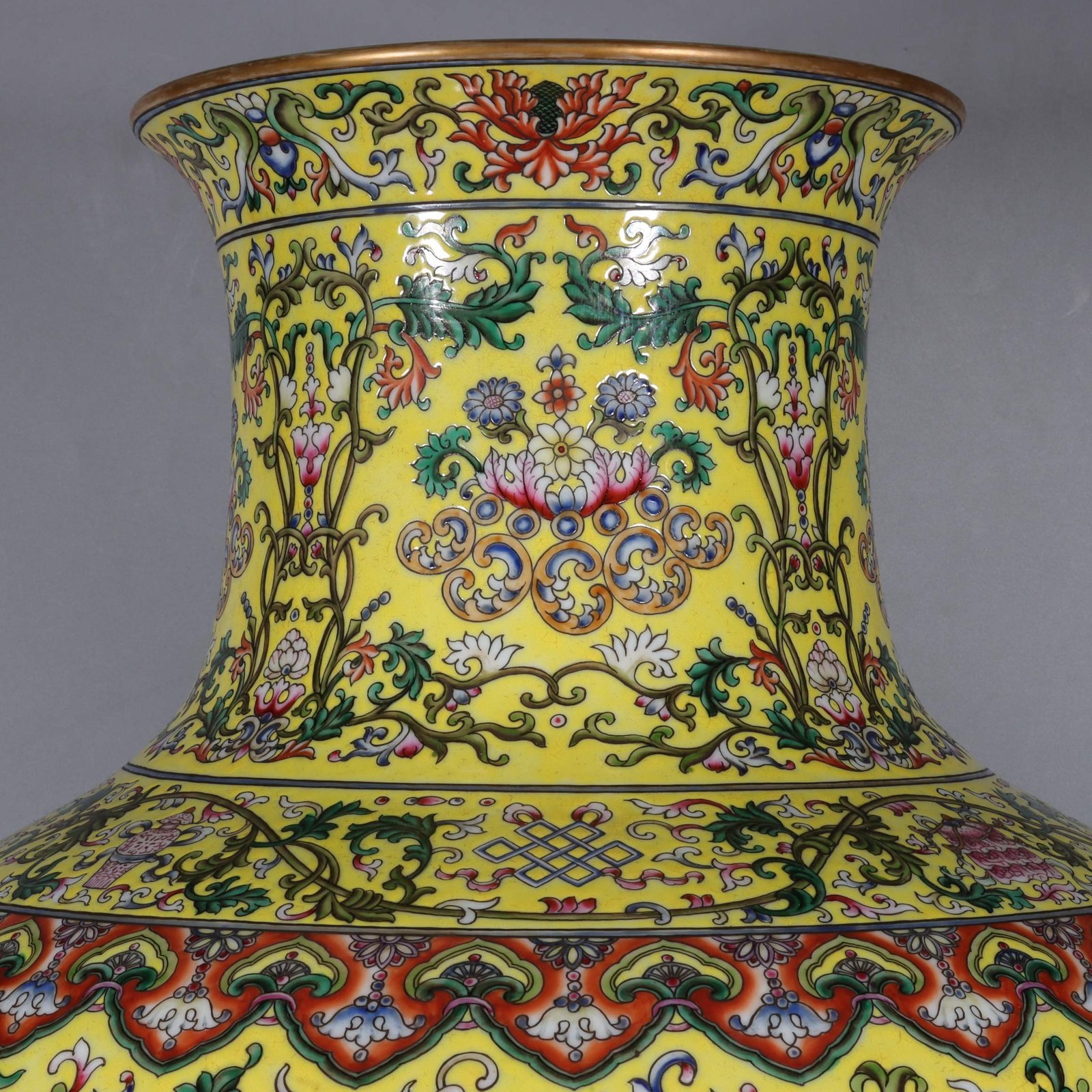 Qing Dynasty Qianlong yellow ground pastel gilded lion-eared vase with lotus flowers