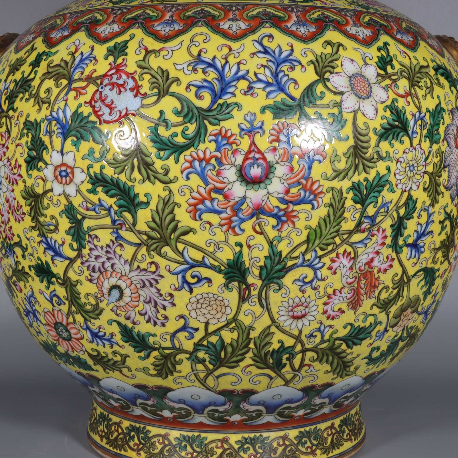 Qing Dynasty Qianlong yellow ground pastel gilded lion-eared vase with lotus flowers