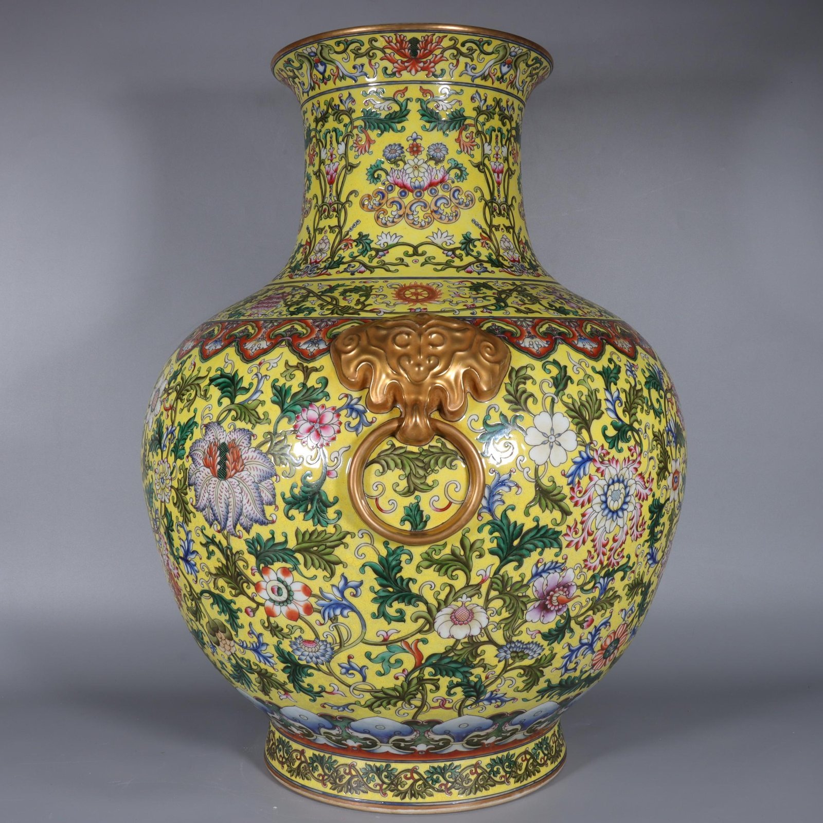 Qing Dynasty Qianlong yellow ground pastel gilded lion-eared vase with lotus flowers