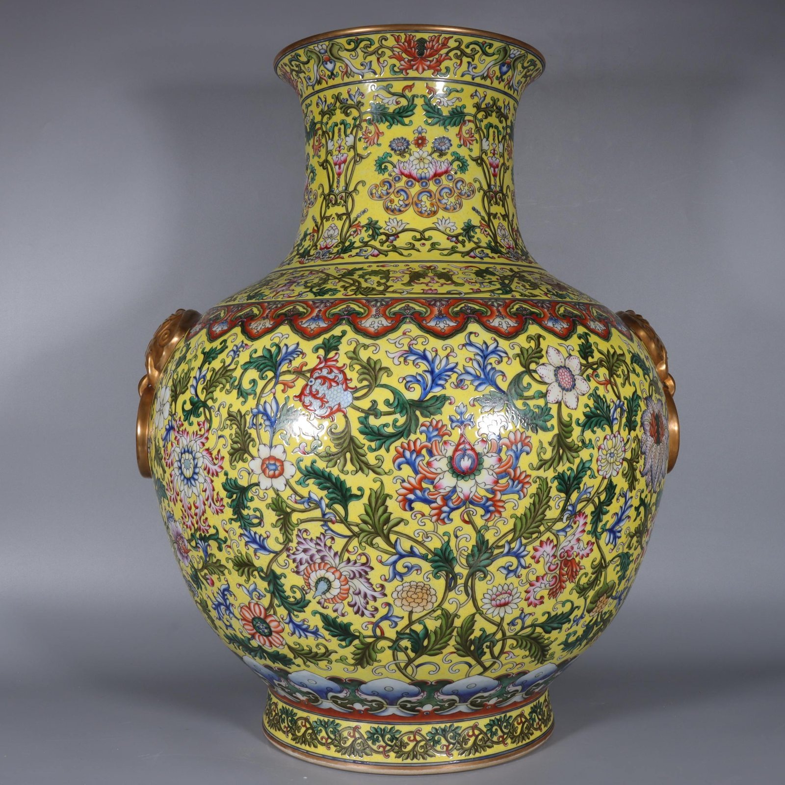 Qing Dynasty Qianlong yellow ground pastel gilded lion-eared vase with lotus flowers