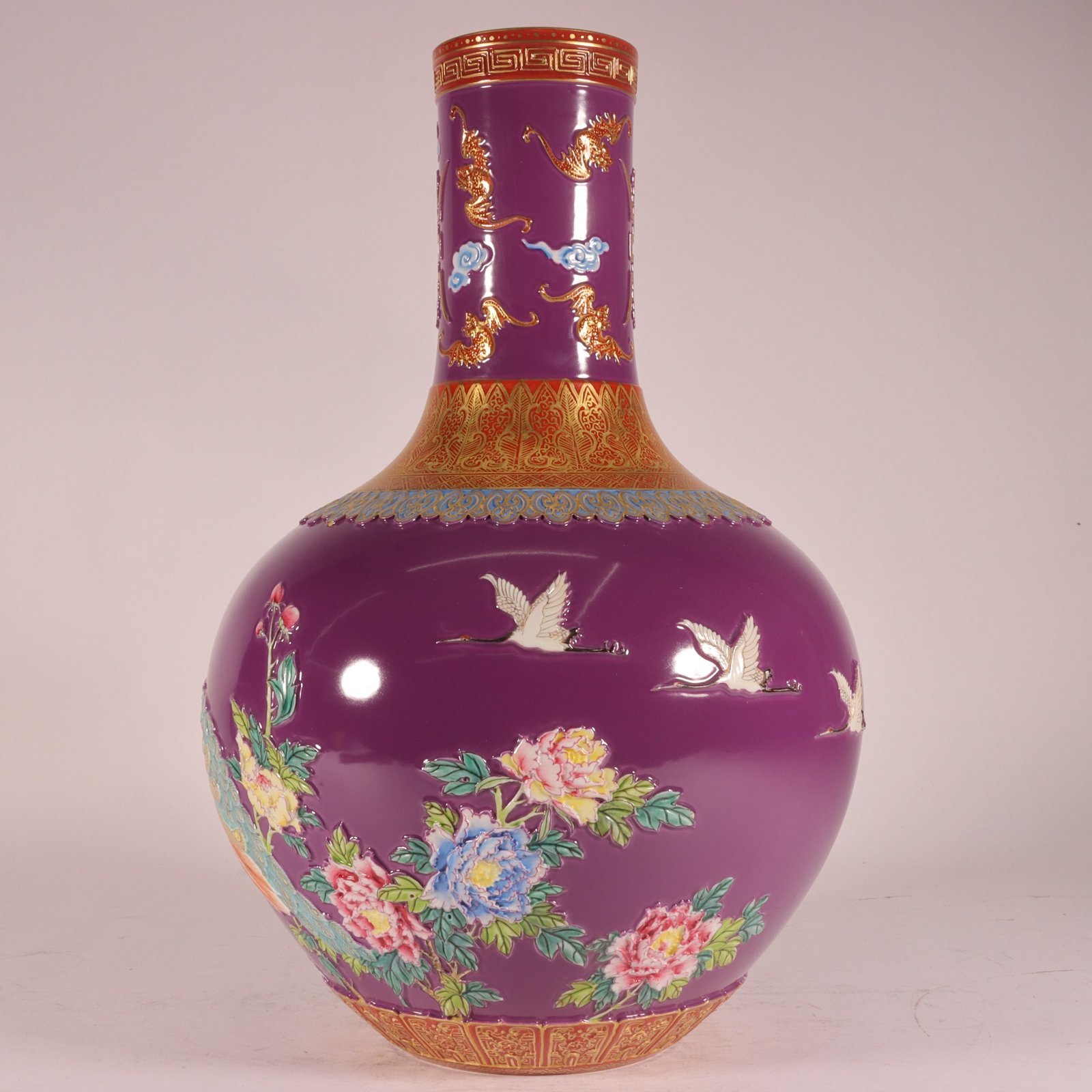 Qing Dynasty Qianlong enamel purple ground carved gold phoenix celestial sphere vase