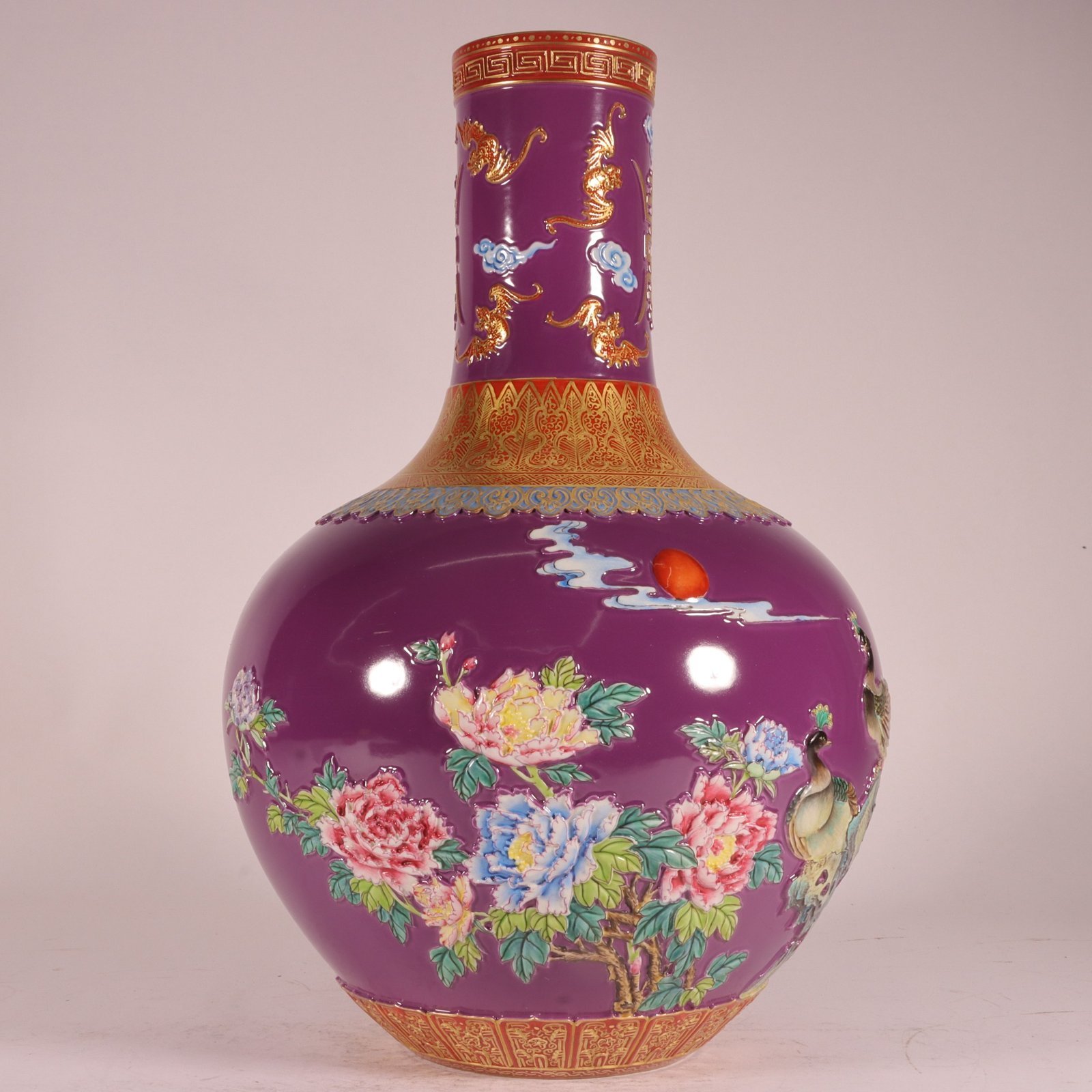 Qing Dynasty Qianlong enamel purple ground carved gold phoenix celestial sphere vase