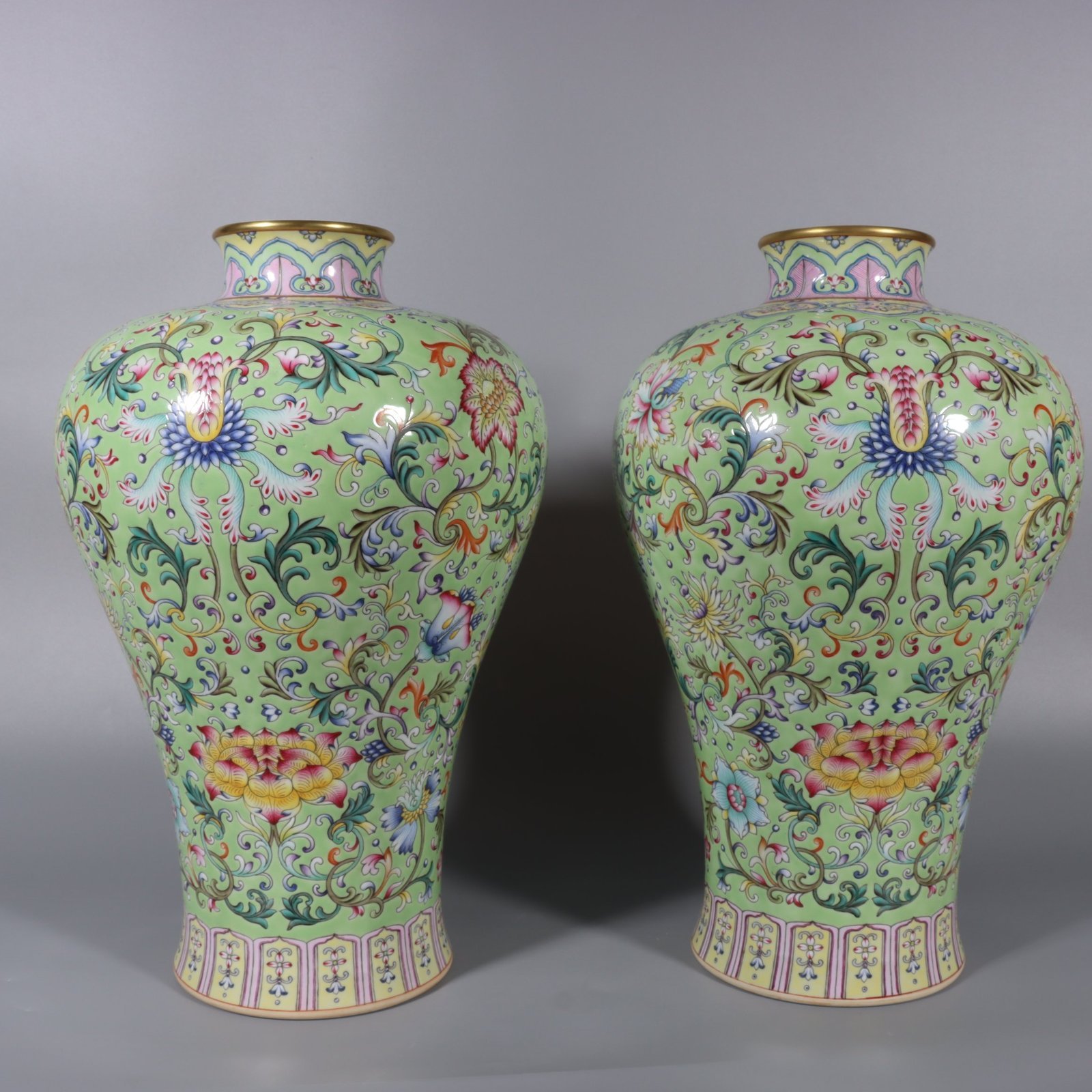 Qing Dynasty Qianlong pair of pastel turquoise and green ground lotus and plum vases