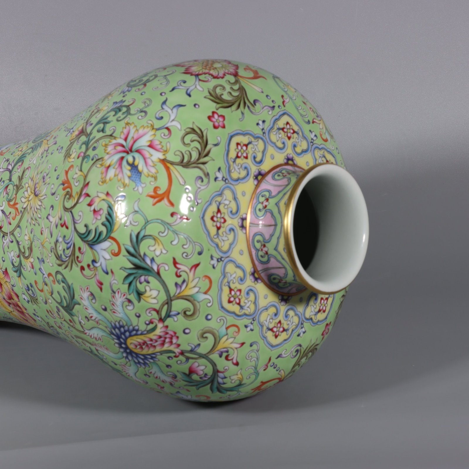 Qing Dynasty Qianlong pair of pastel turquoise and green ground lotus and plum vases