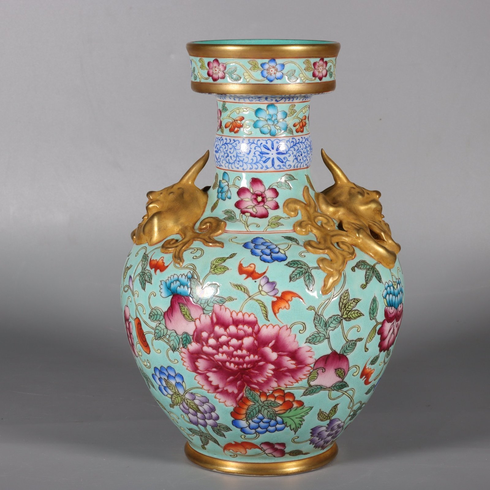 Qing Dynasty Qianlong pastel green lotus and animal ear vase