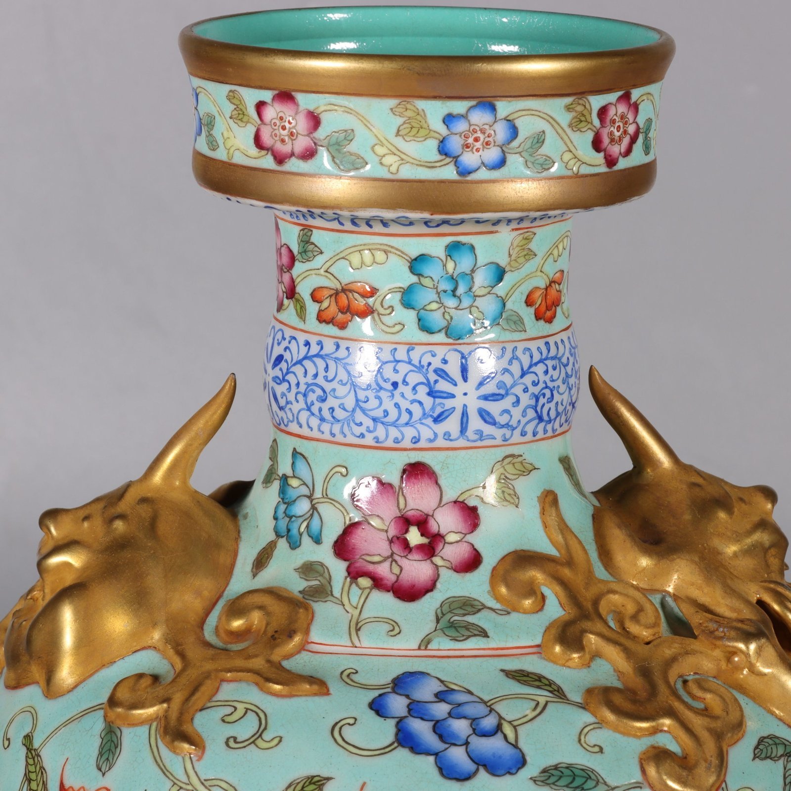 Qing Dynasty Qianlong pastel green lotus and animal ear vase