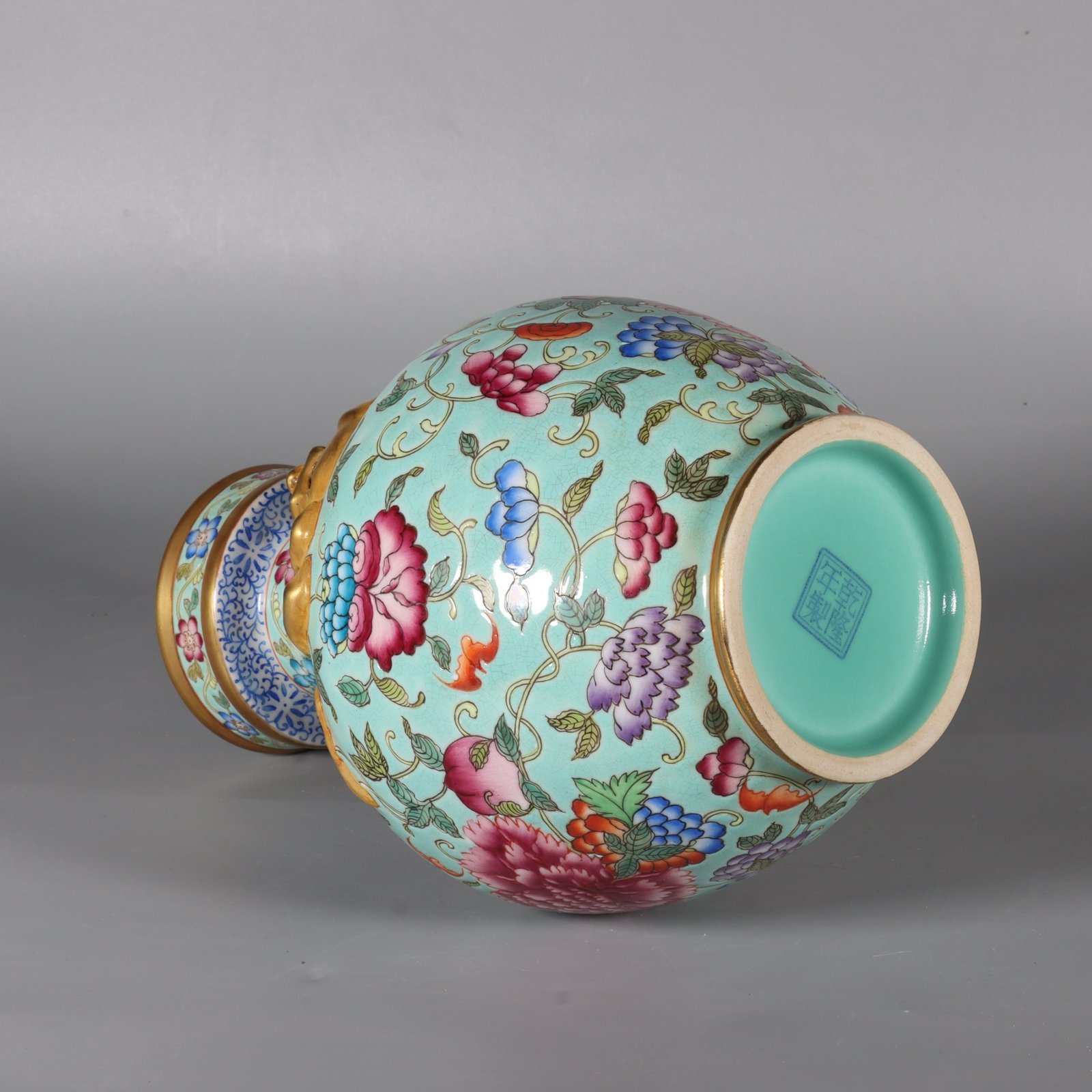 Qing Dynasty Qianlong pastel green lotus and animal ear vase