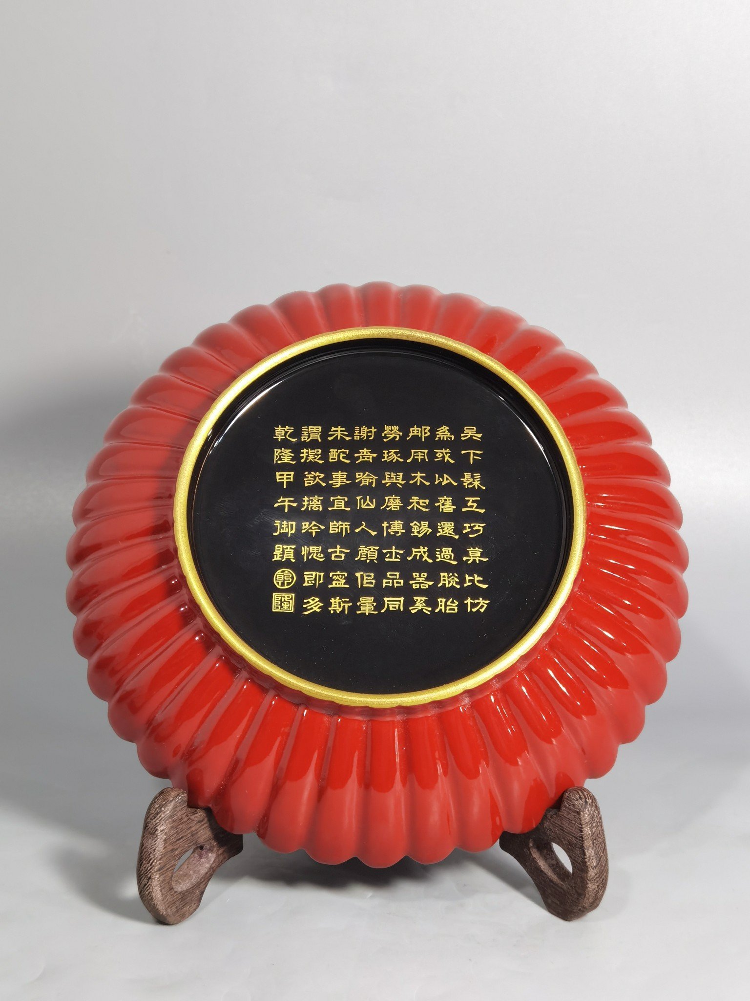 Qing Dynasty Qianlong coral red ground black ground pastel plum blossom melon petal plate