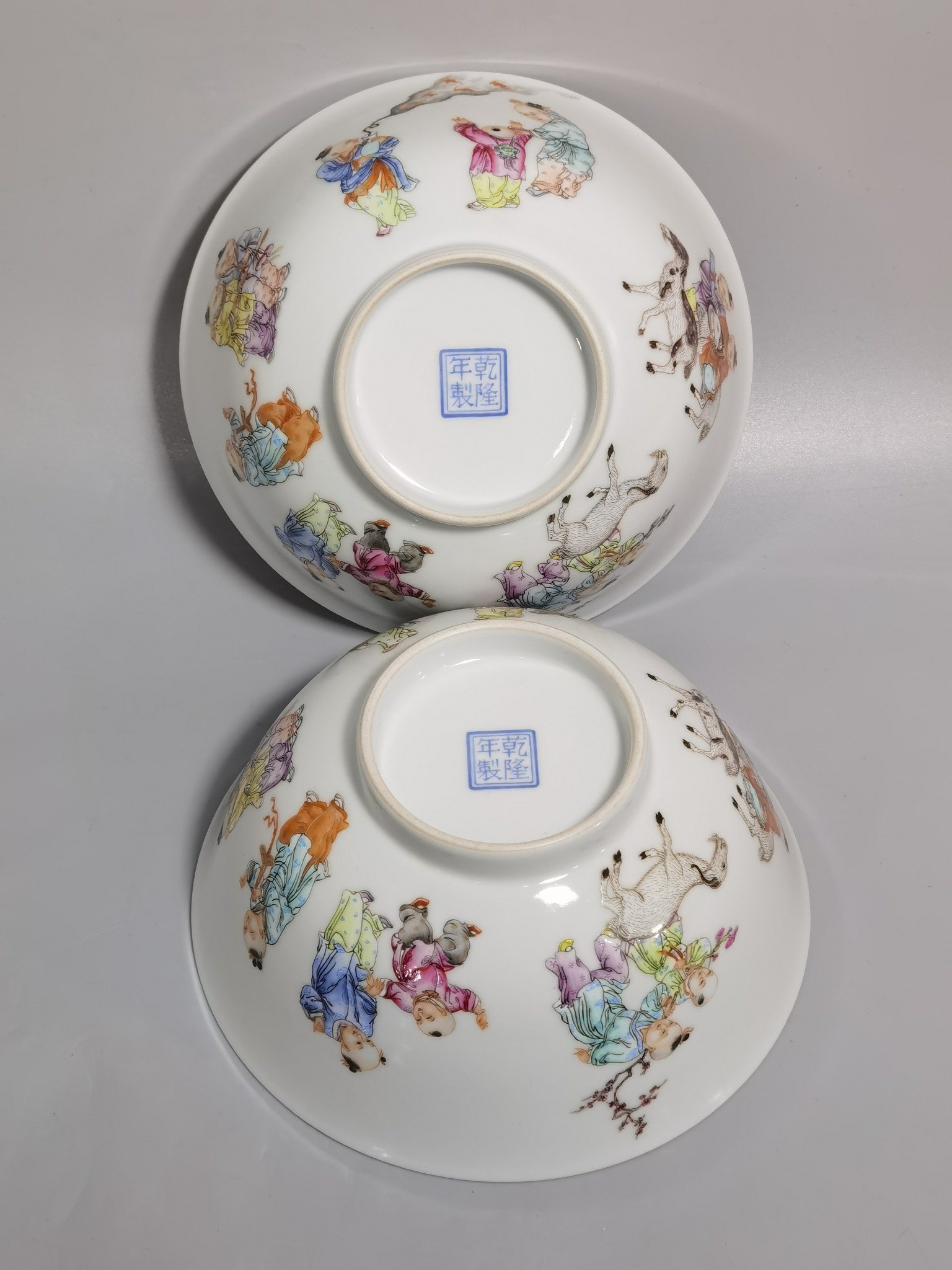 Qing Dynasty Qianlong pair of enamel baby playing bowls