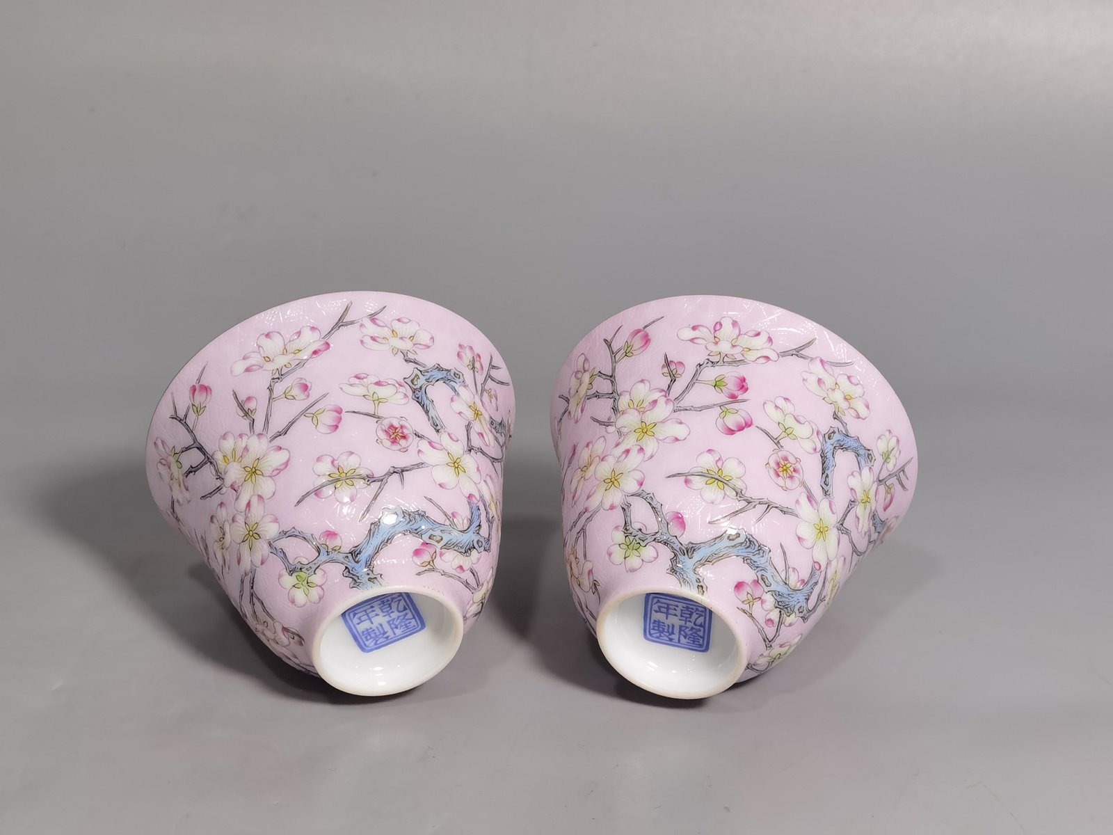 Qing Dynasty Qianlong pair of enamel pink ground plum blossom cups