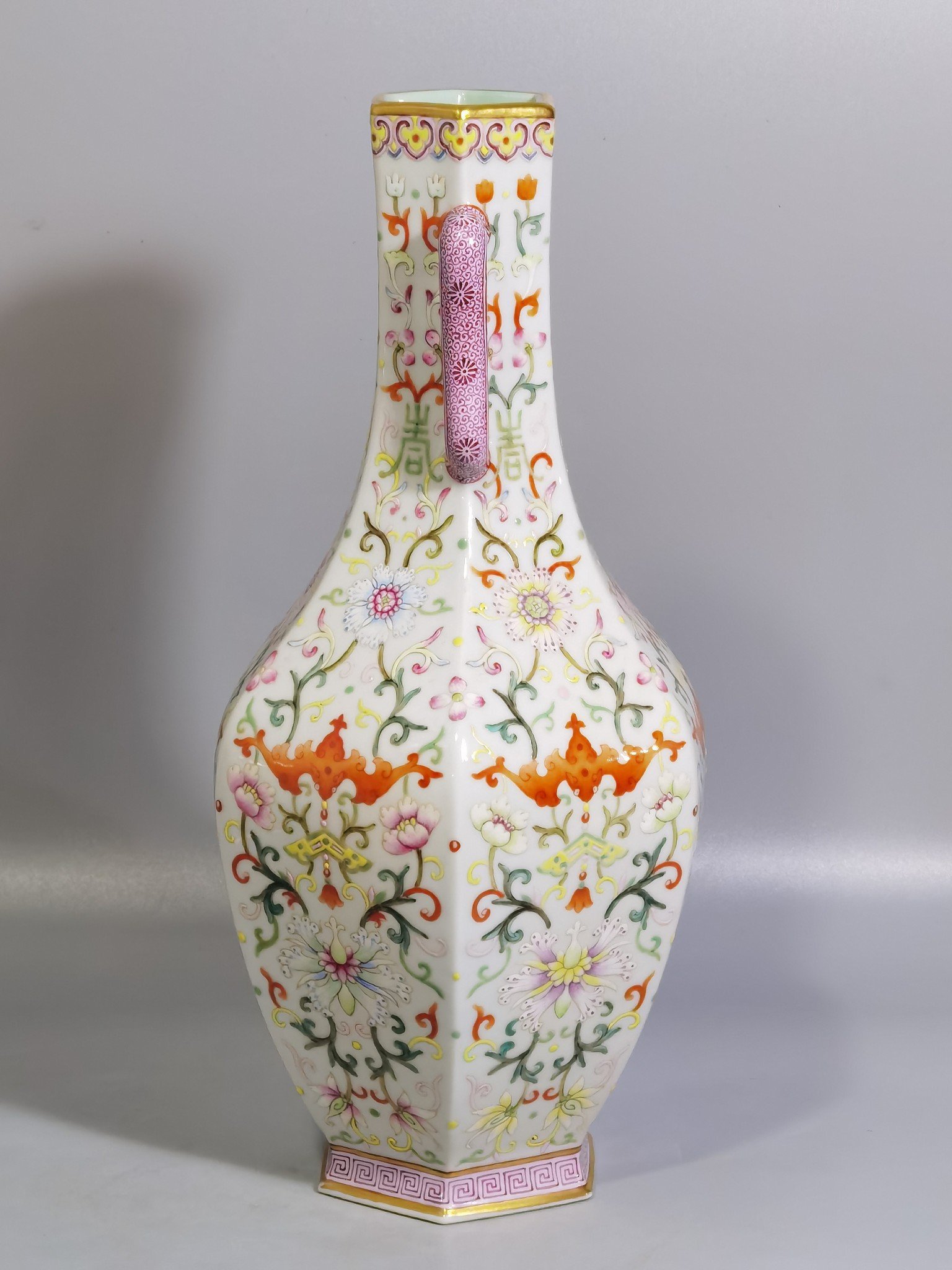 Qing Dynasty Qianlong pair of white-ground pastel-painted double-eared hexagonal vases