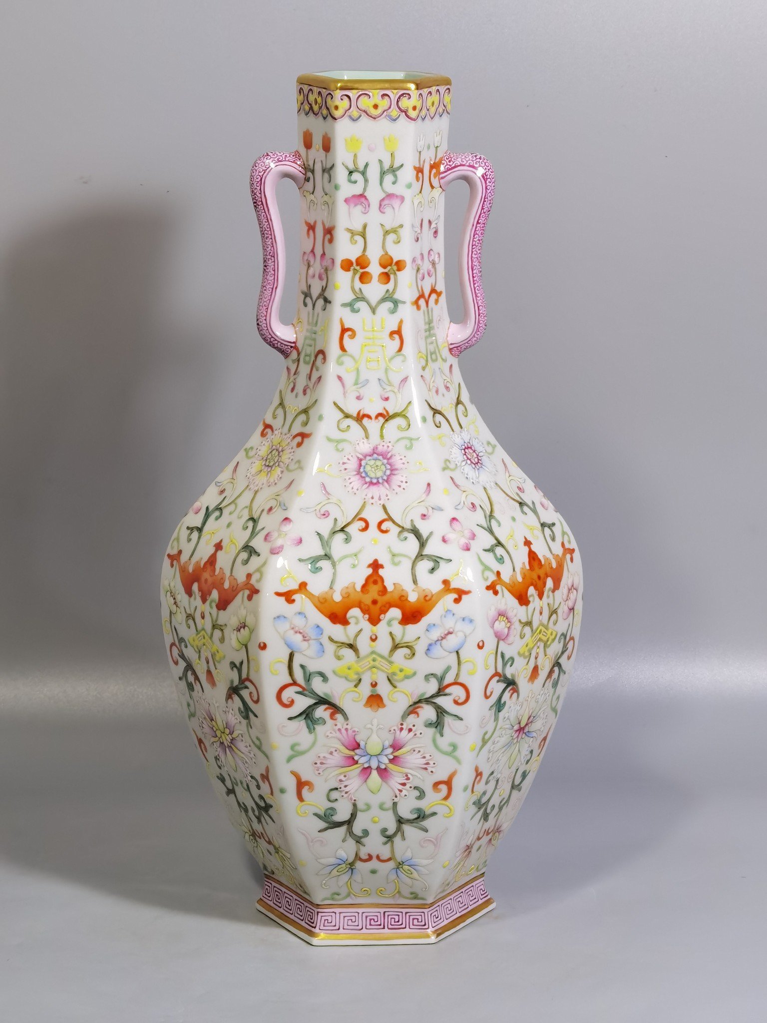Qing Dynasty Qianlong pair of white-ground pastel-painted double-eared hexagonal vases