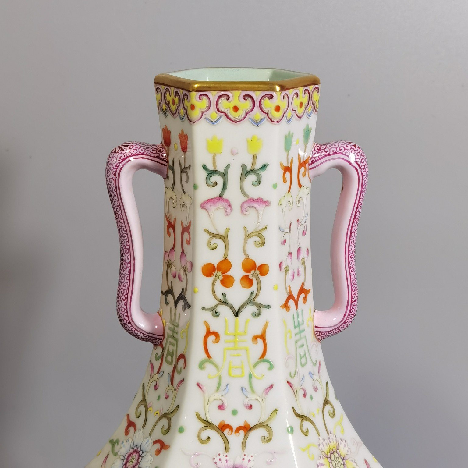 Qing Dynasty Qianlong pair of white-ground pastel-painted double-eared hexagonal vases