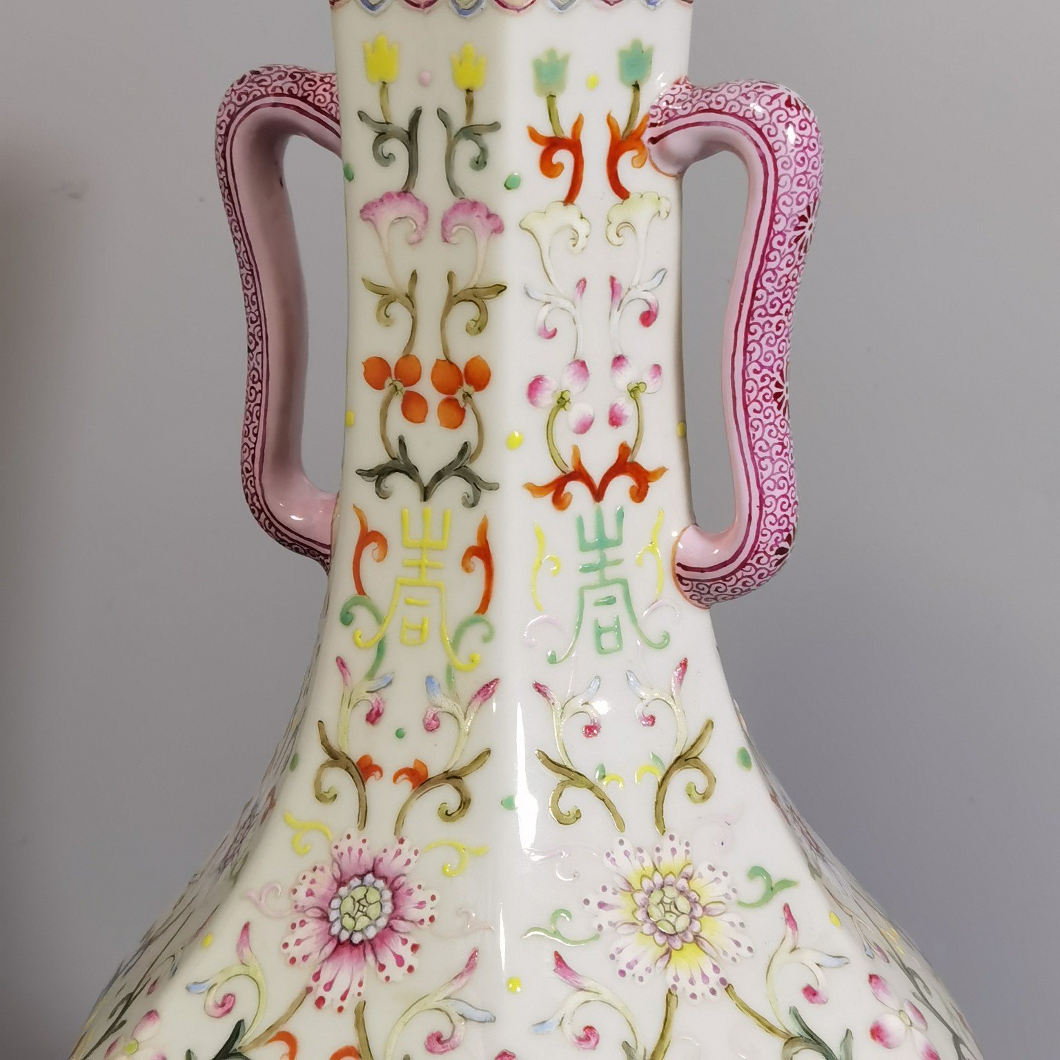Qing Dynasty Qianlong pair of white-ground pastel-painted double-eared hexagonal vases