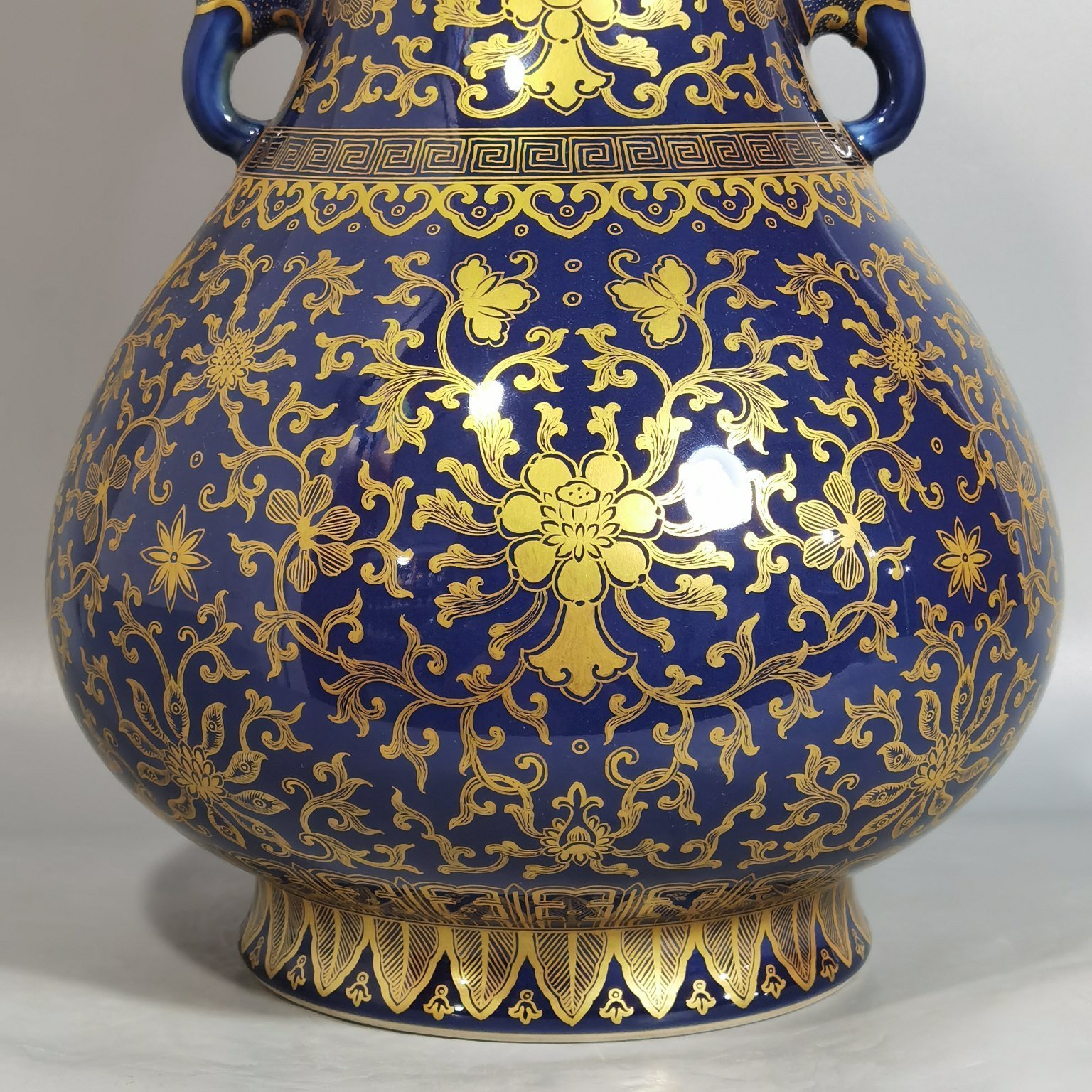 Qing Dynasty Qianlong purse blue glaze painted with gold and longevity lotus pattern elephant ear vase