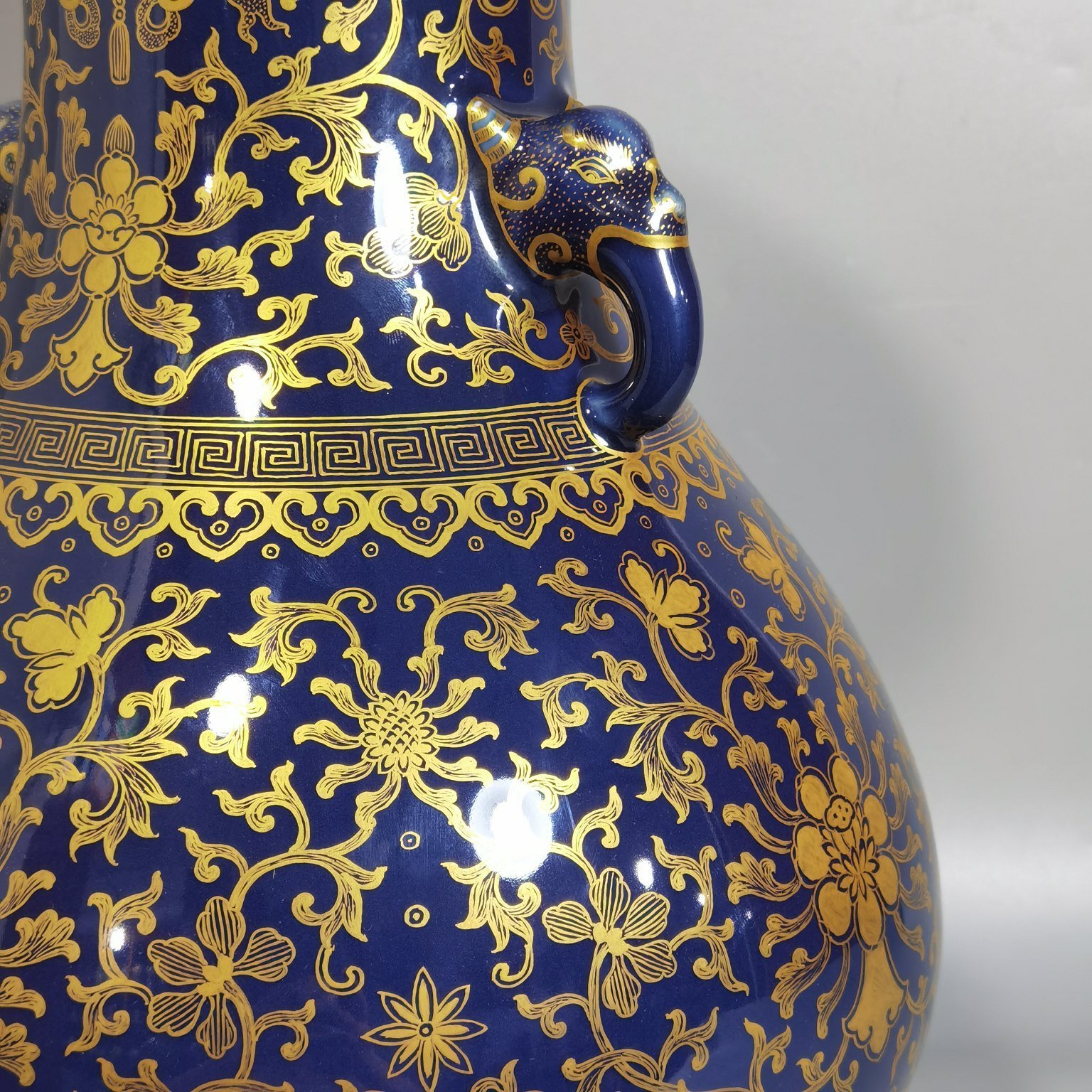 Qing Dynasty Qianlong purse blue glaze painted with gold and longevity lotus pattern elephant ear vase