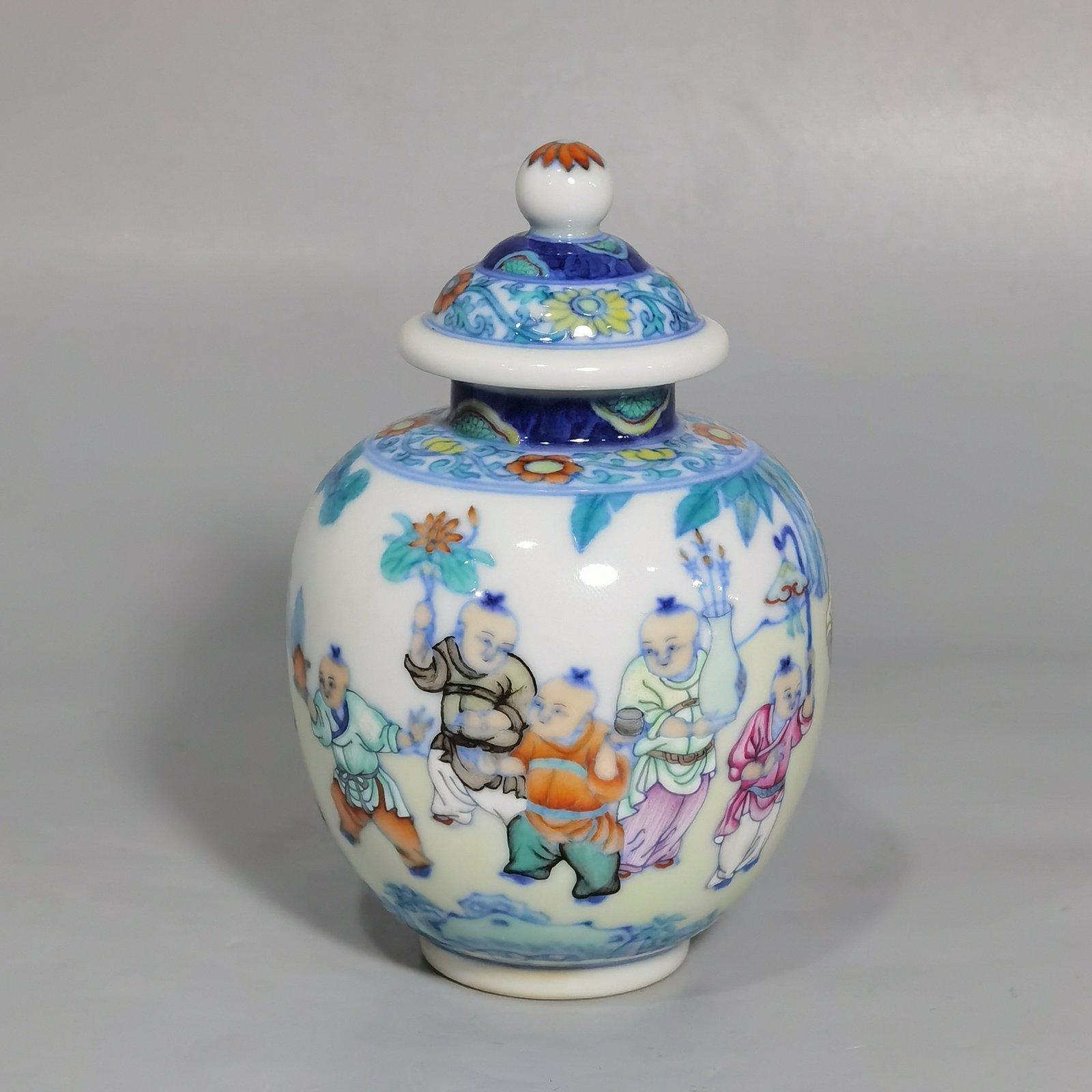 Qing Dynasty Qianlong blue and white colored baby playing picture covered jar