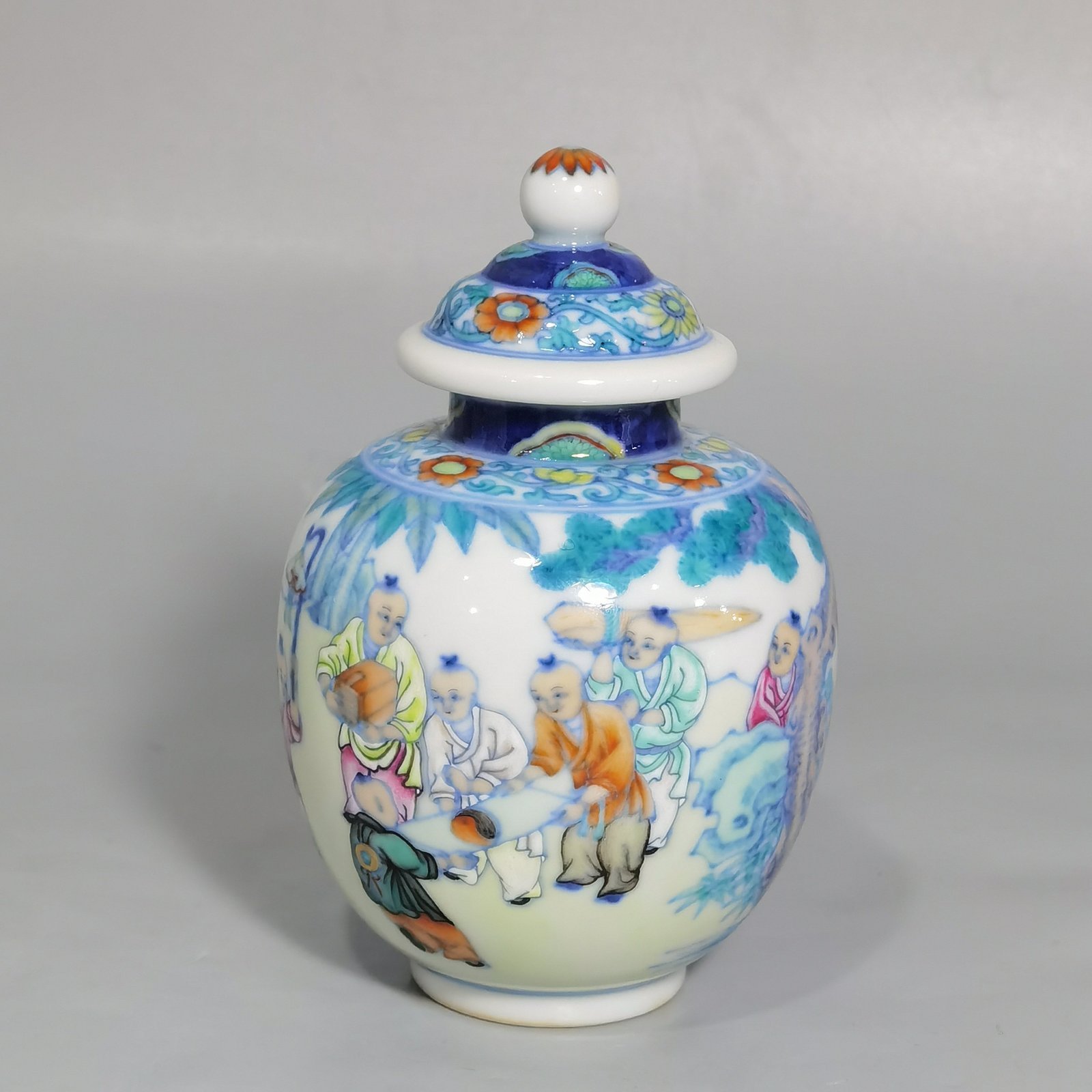 Qing Dynasty Qianlong blue and white colored baby playing picture covered jar
