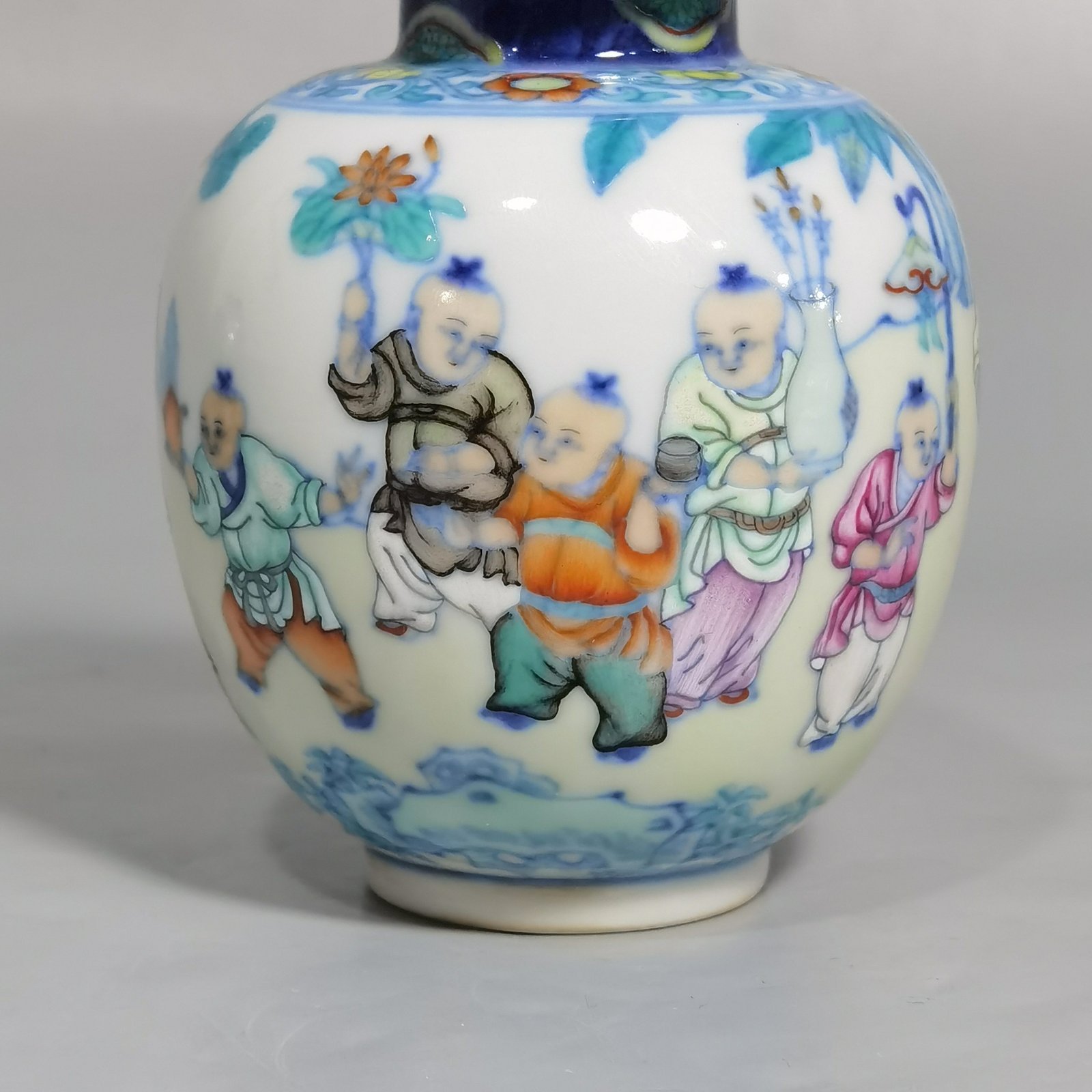 Qing Dynasty Qianlong blue and white colored baby playing picture covered jar