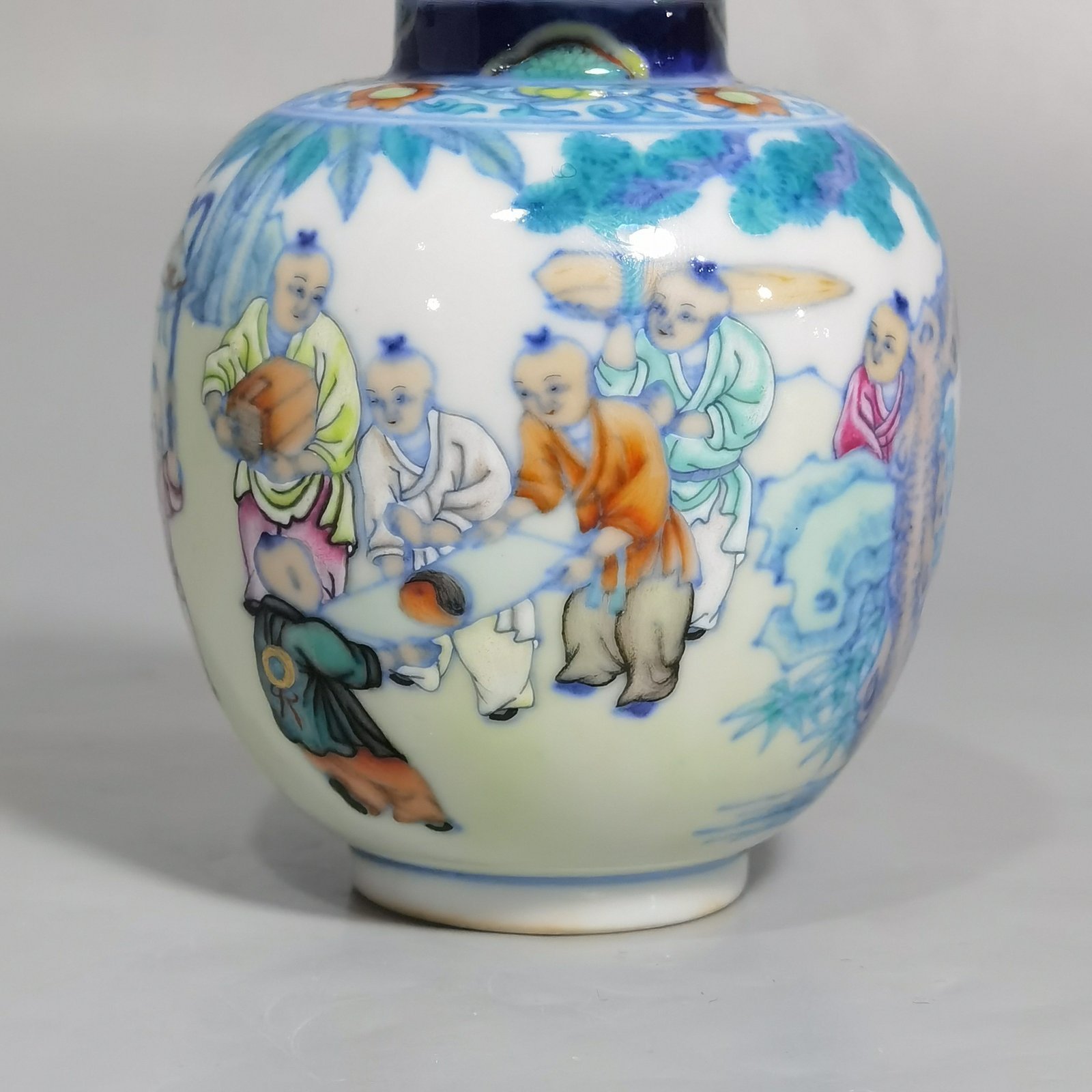 Qing Dynasty Qianlong blue and white colored baby playing picture covered jar