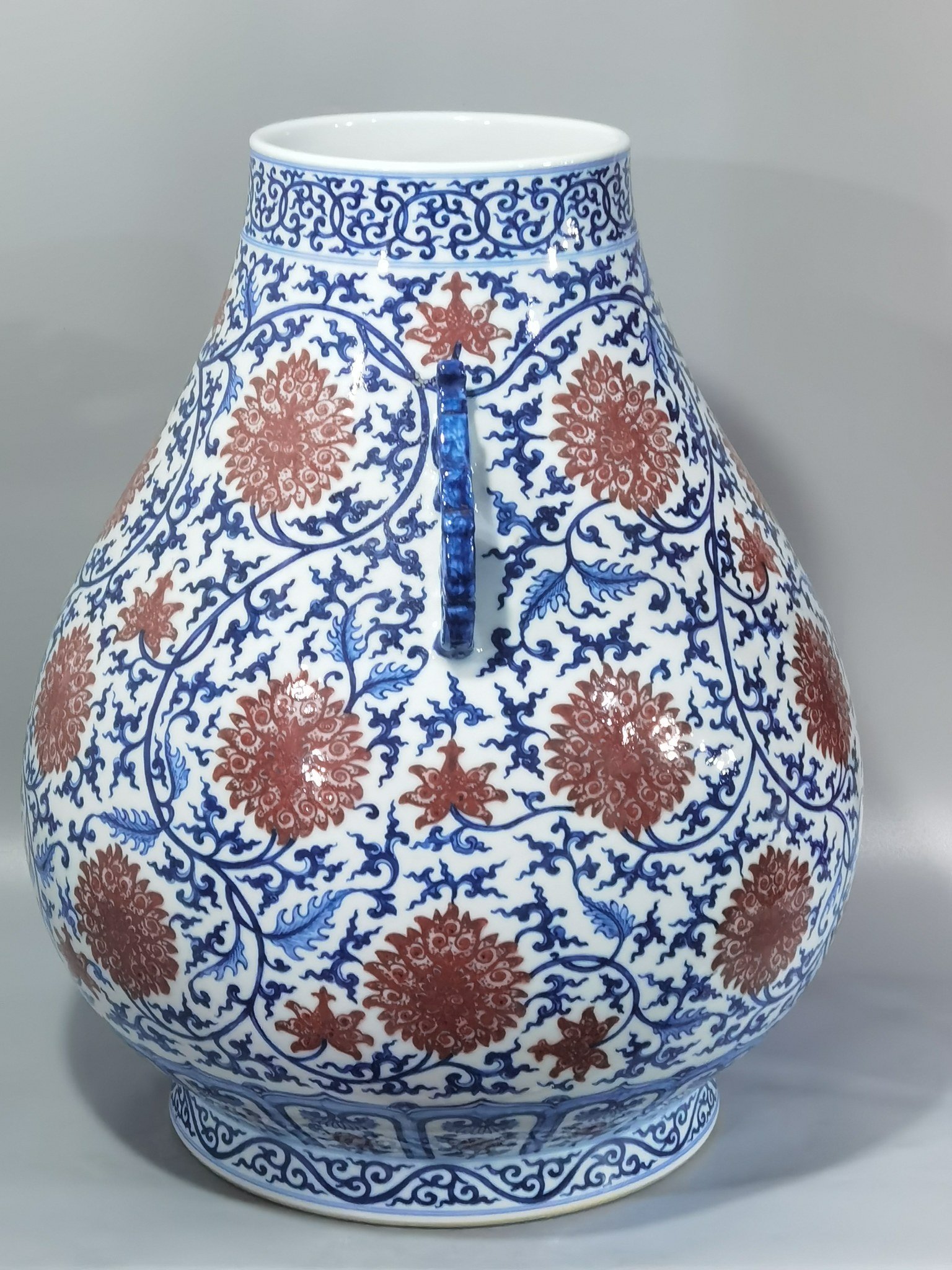 Qing Dynasty Qianlong blue and white glazed red lotus pattern Ruyi ear blessing barrel