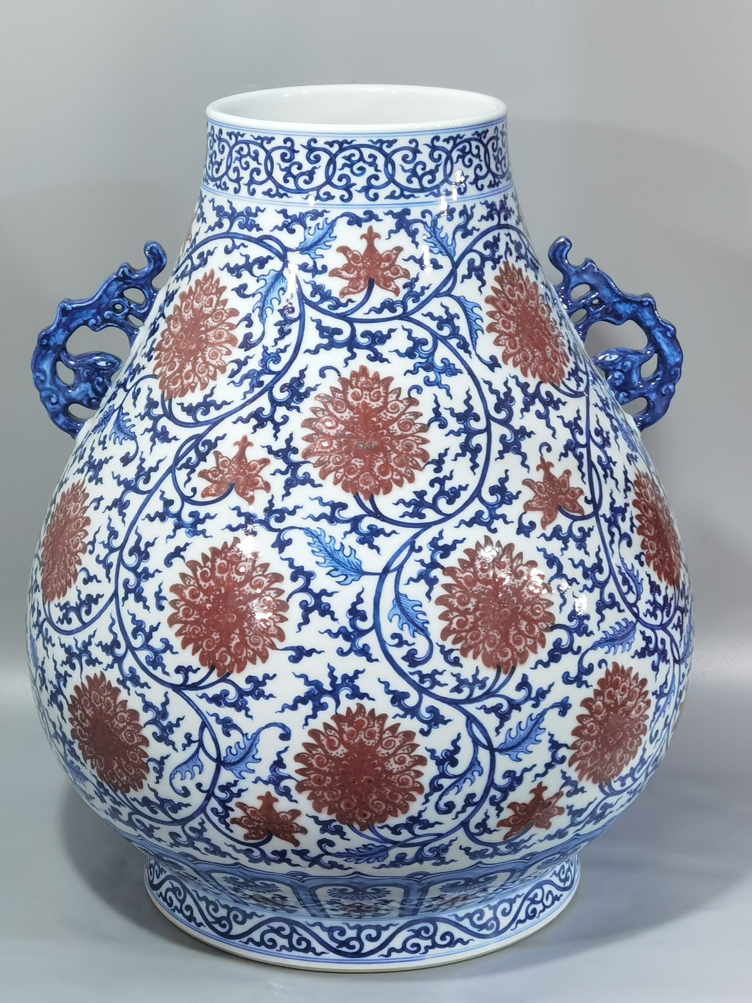 Qing Dynasty Qianlong blue and white glazed red lotus pattern Ruyi ear blessing barrel