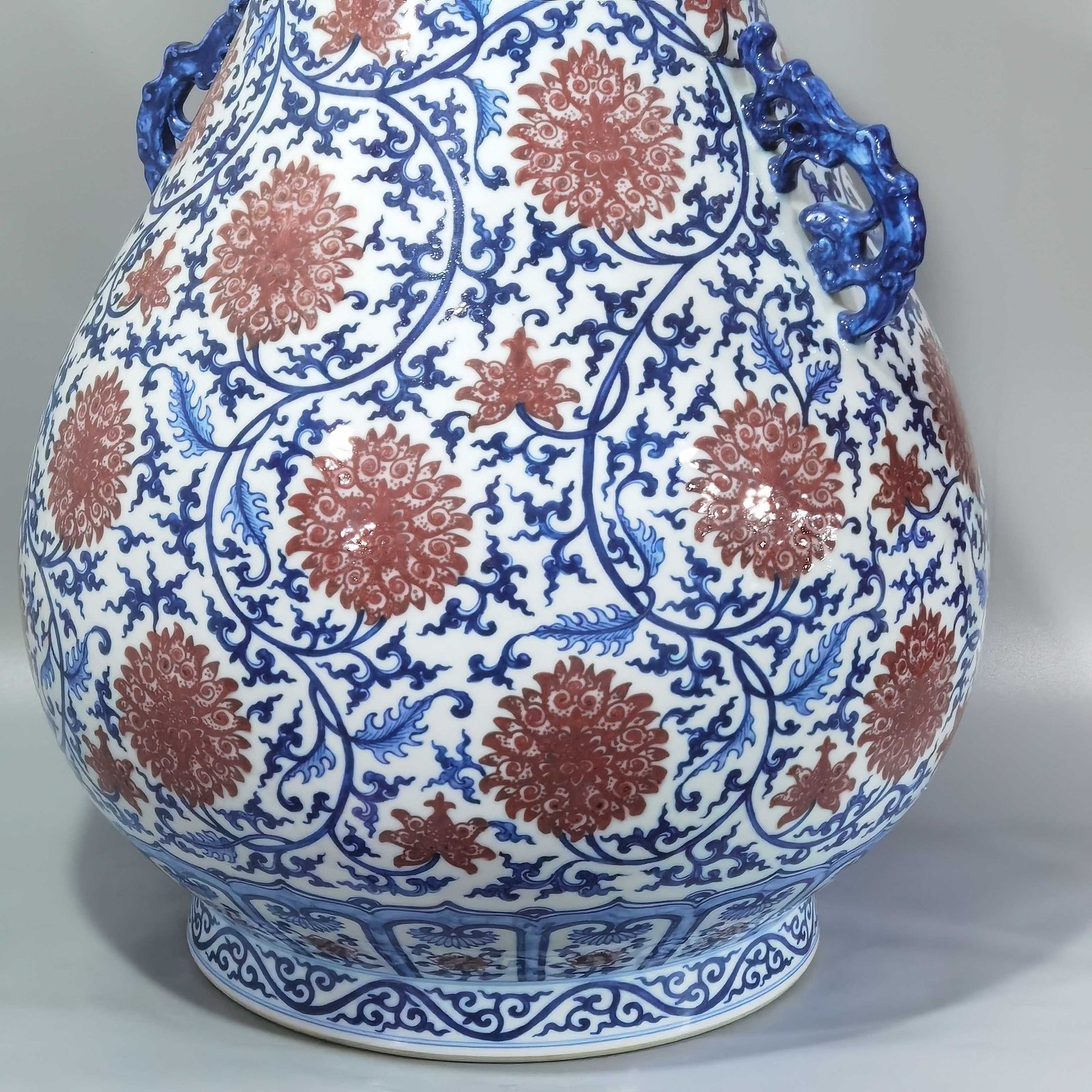 Qing Dynasty Qianlong blue and white glazed red lotus pattern Ruyi ear blessing barrel