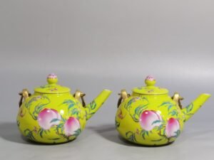 Qing Dynasty Qianlong yellow ground pastel five peach and five blessing teapot