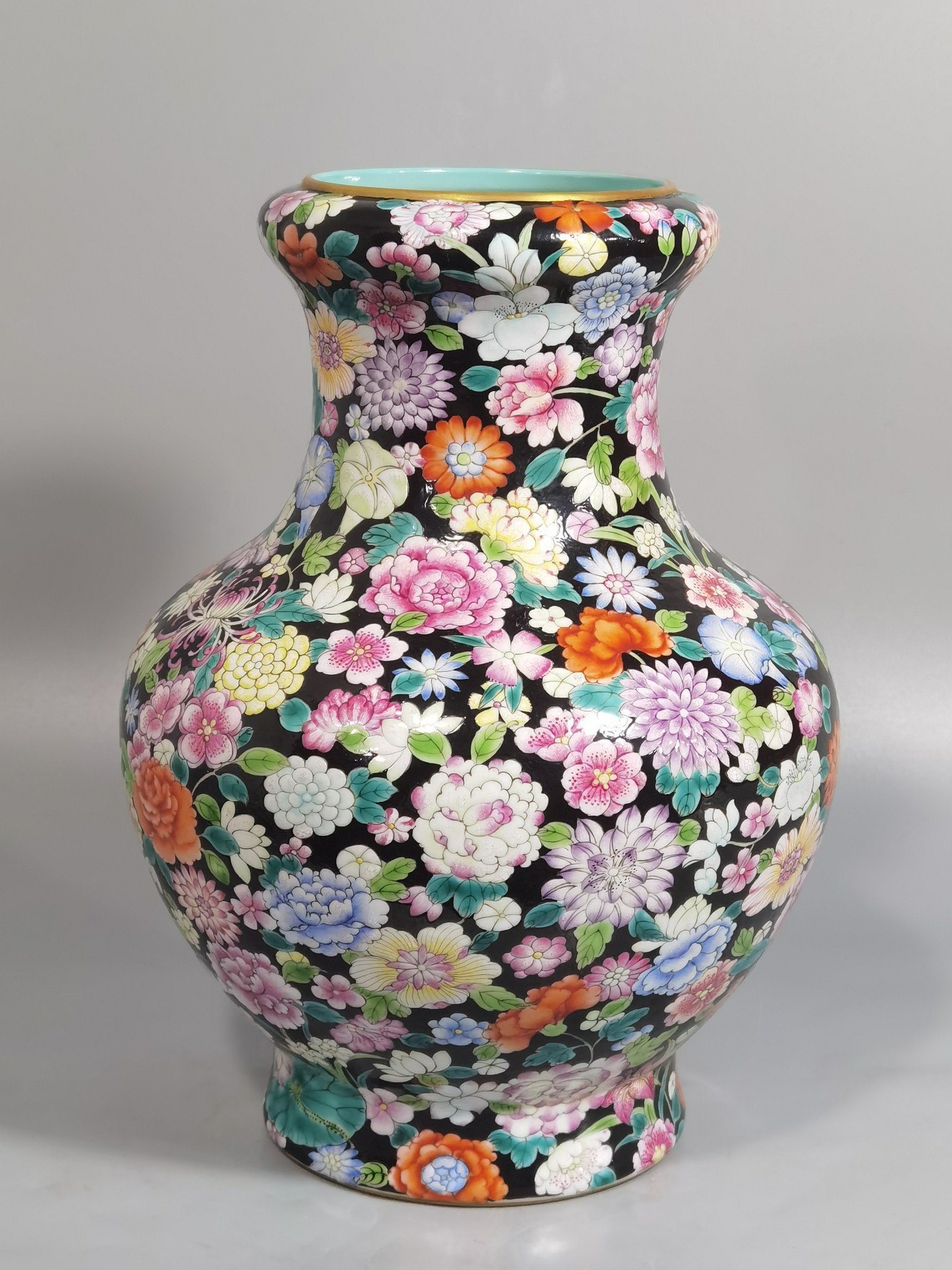 Qing Dynasty Qianlong black ground pastel colored mouth-washing bottle