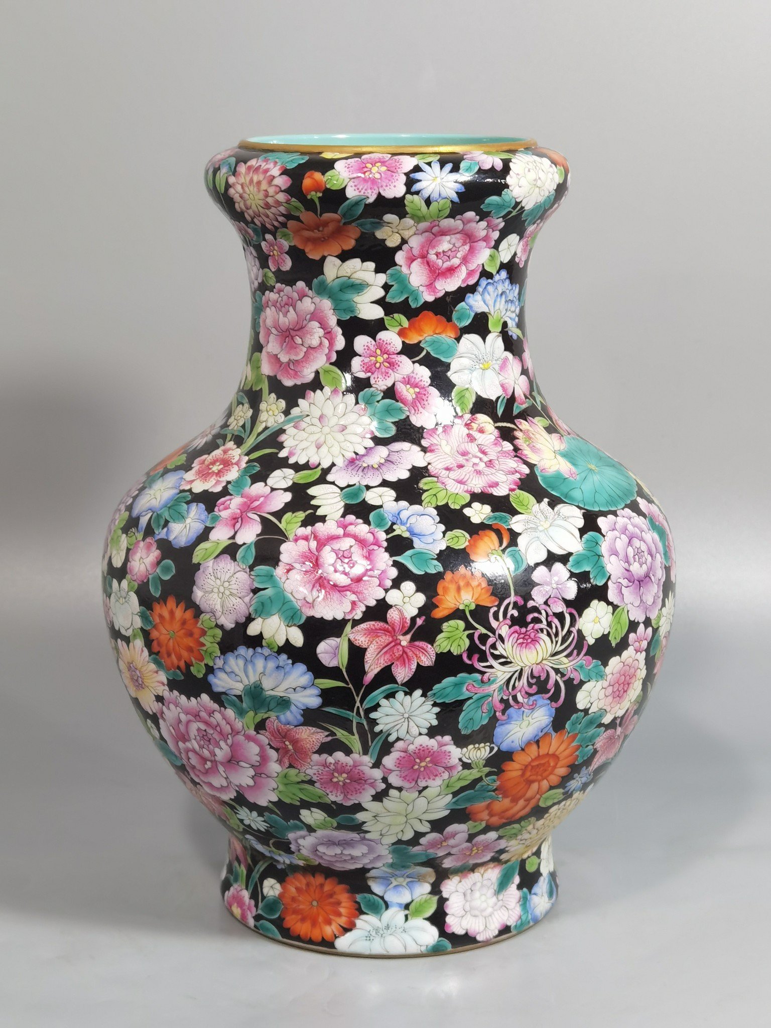 Qing Dynasty Qianlong black ground pastel colored mouth-washing bottle