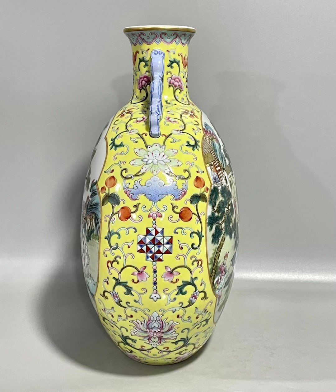 Qing Dynasty Qianlong Yangcai yellow ground figure with two ears holding moon vase