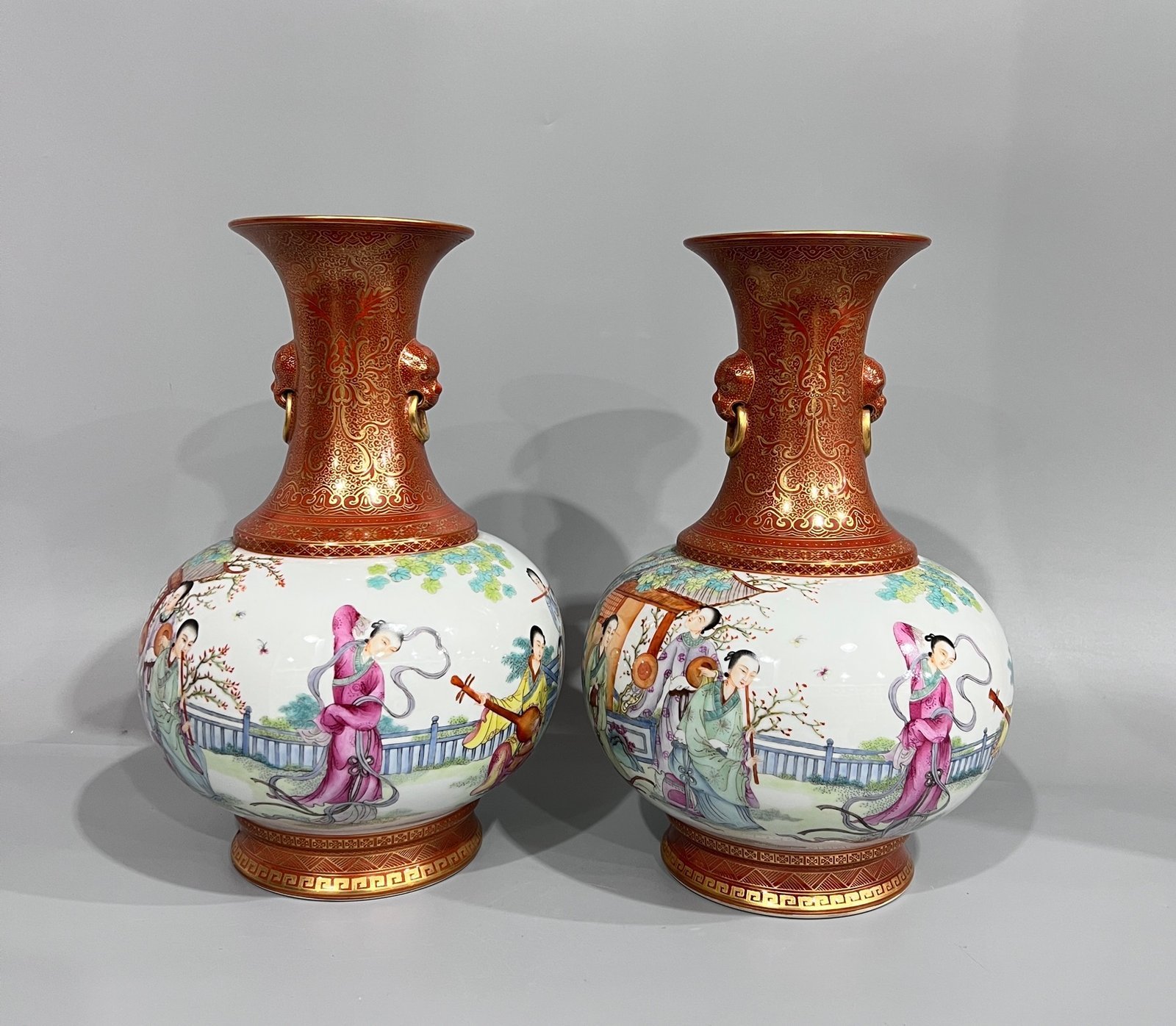 Qing Dynasty alum red gilt on top and bottom and pastel figures pair of two-ear vase