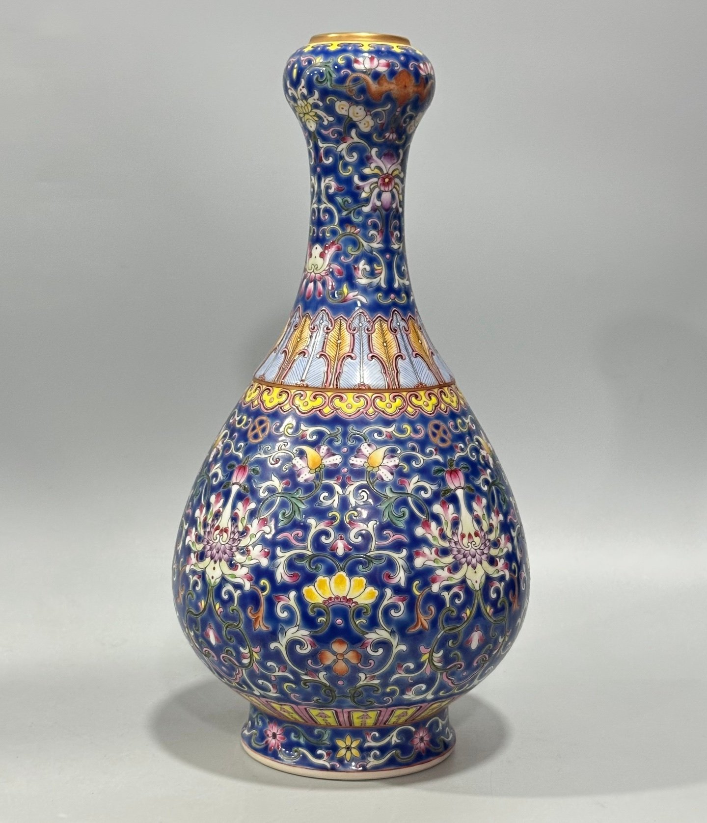 Qing Dynasty Qianlong Yangcai blue ground bat passion fruit and garlic vase