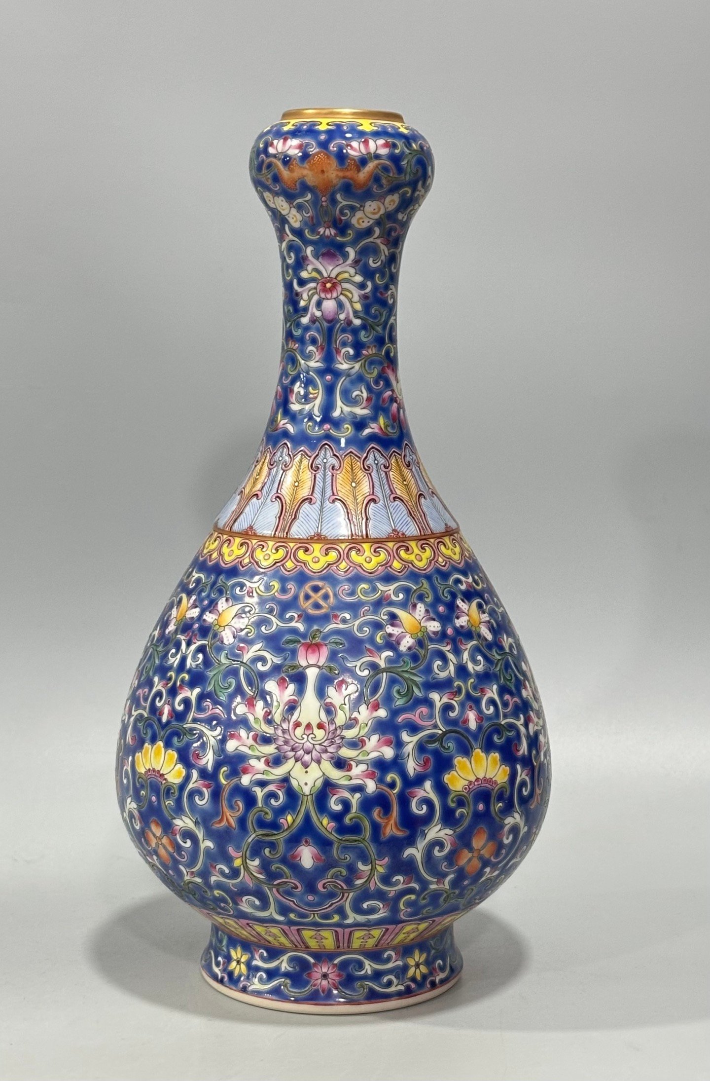 Qing Dynasty Qianlong Yangcai blue ground bat passion fruit and garlic vase