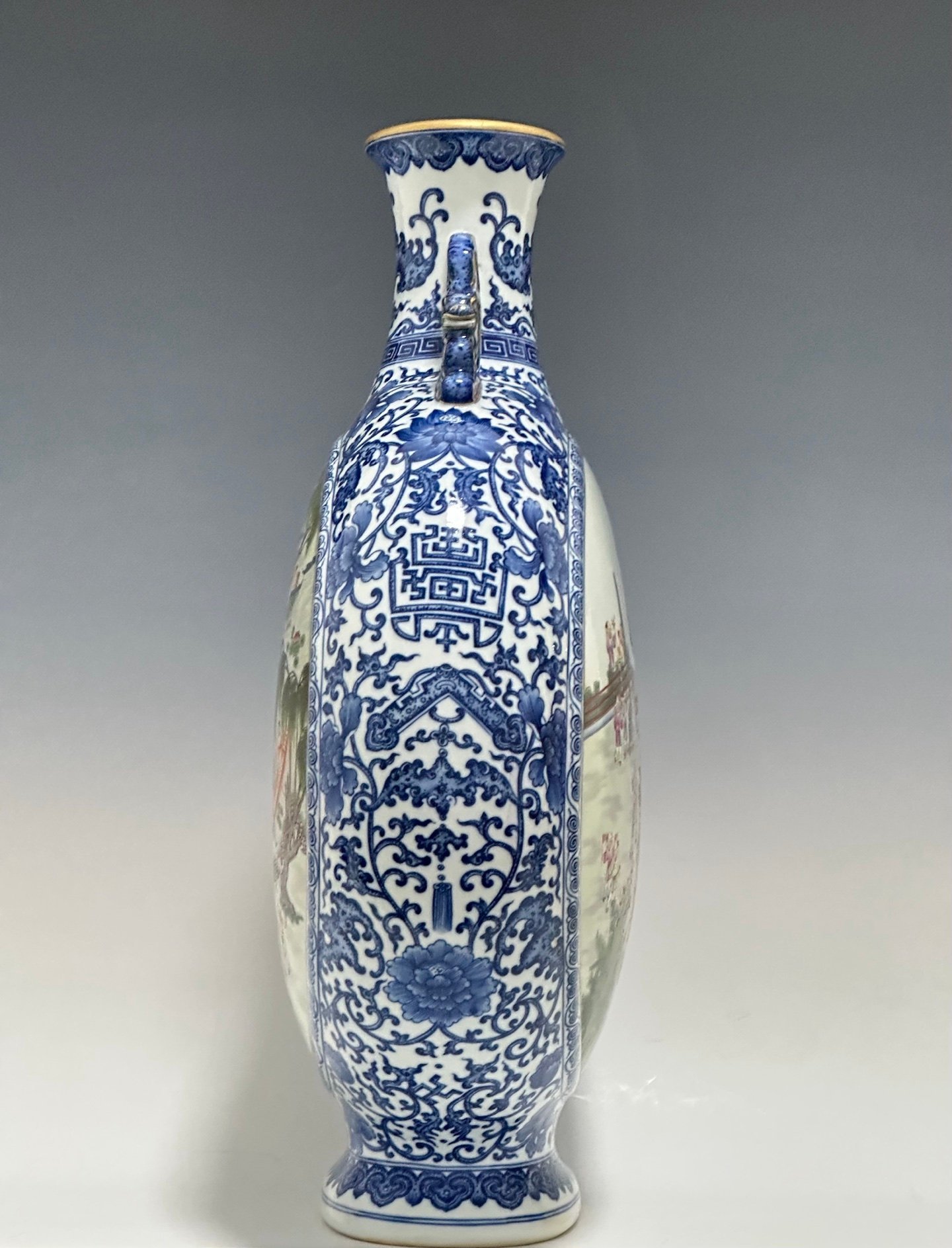 Qing Dynasty Qianlong Pastel blue and white flowers with hundred figures double ears holding the moon vase
