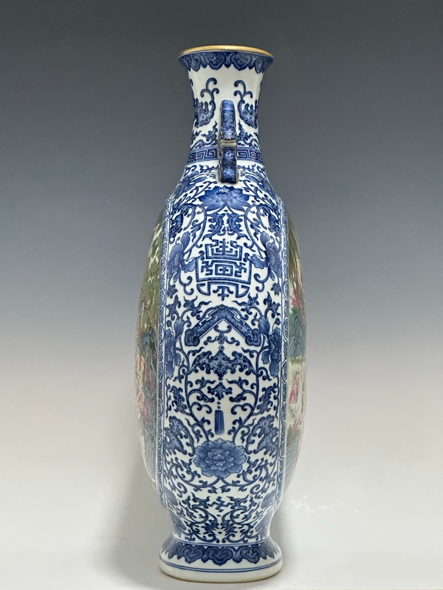 Qing Dynasty Qianlong Pastel blue and white flowers with hundred figures double ears holding the moon vase