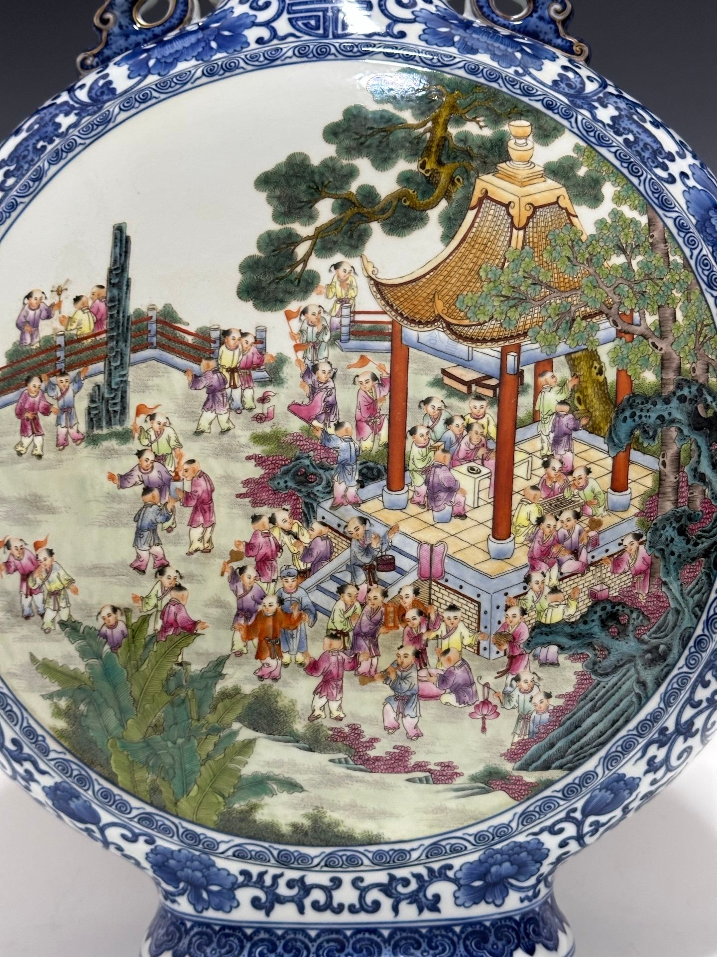 Qing Dynasty Qianlong Pastel blue and white flowers with hundred figures double ears holding the moon vase