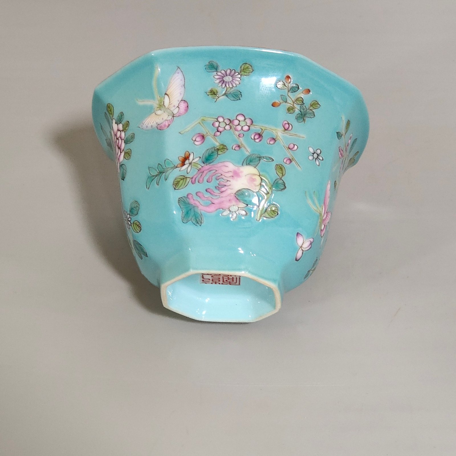 Qing Dynasty Qianlong turquoise green branched flowers and three more butterflies octagonal cup